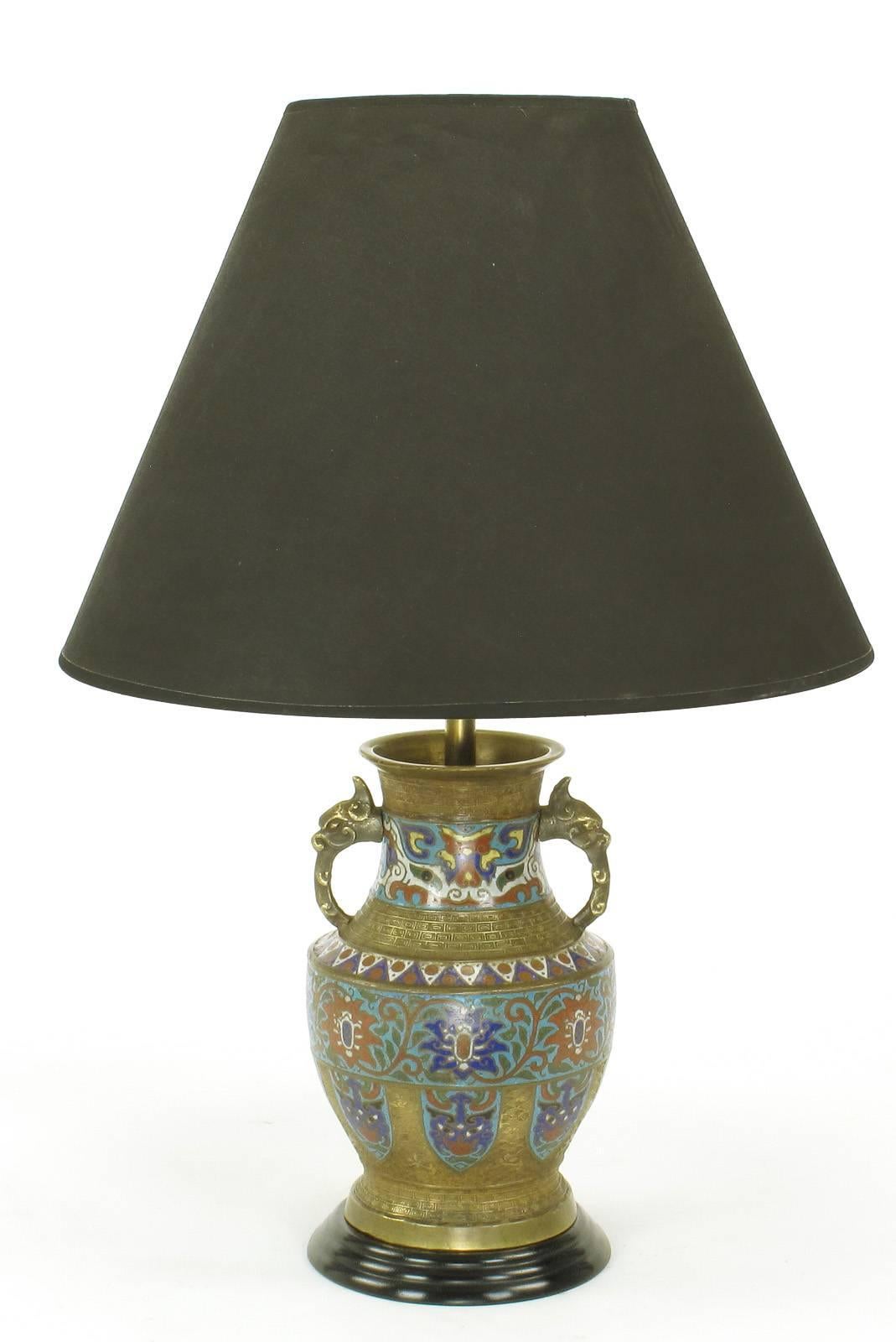 Pair of Japanese brass and champlevé cloisonné table lamps custom-made into table lamps. Handled vase bodies are brass, mounted on black lacquered wood bases with recessed black lacquered wood caps. Brass dragon form handles, brass stem and double