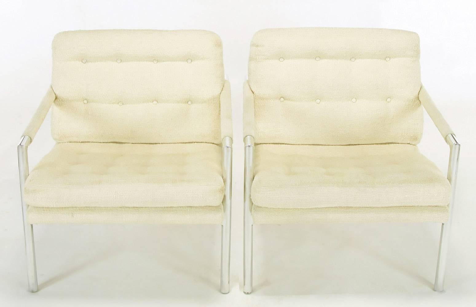 Polished aluminum frame lounge chairs, in the manner of Harvey Probber, with ivory silk/linen blended upholstery. Unexpected details come in the form of exposed oversized flat head screws that support the combination seat and back platform. Button
