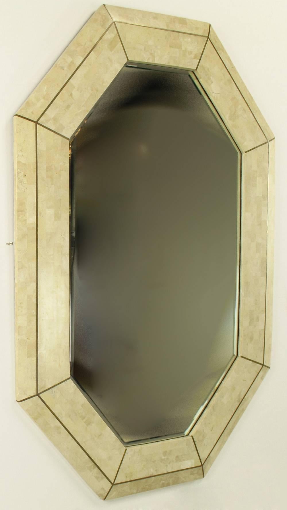 Tessellated fossil stone and inlaid brass mirror by Maitland-Smith. Octagonal shape frame is beveled and one inch thick. Mirror is also beveled. Manufactured i the Philippines at the same factory as the similar pieces by Karl Springer and Robert