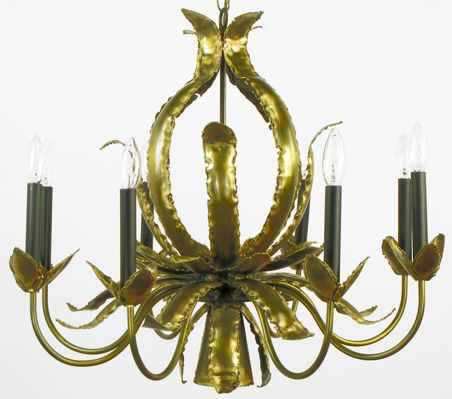 Rare torch cut brass, welded onto the traditional brass chandelier frame. Tom Greene designed what were typically considered Brutalist movement chandeliers, some for Monteverdi Young and the Feldman Company. The torch cut brass strips and formed