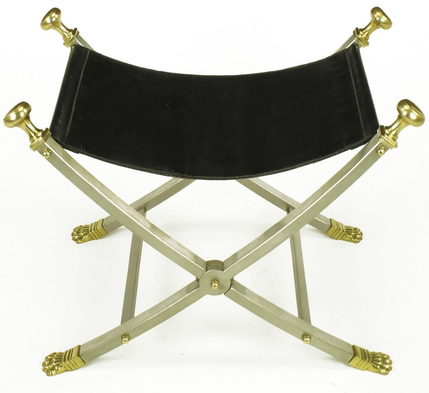 Pair of Maison Jansen sling seat folding Campaign benches. Restored black leather seats with new backing. Brushed nickel over steel frames with brass paw feet and finials. Stamped Italy on underside of feet. 
Appears in the books: 
Jansen: