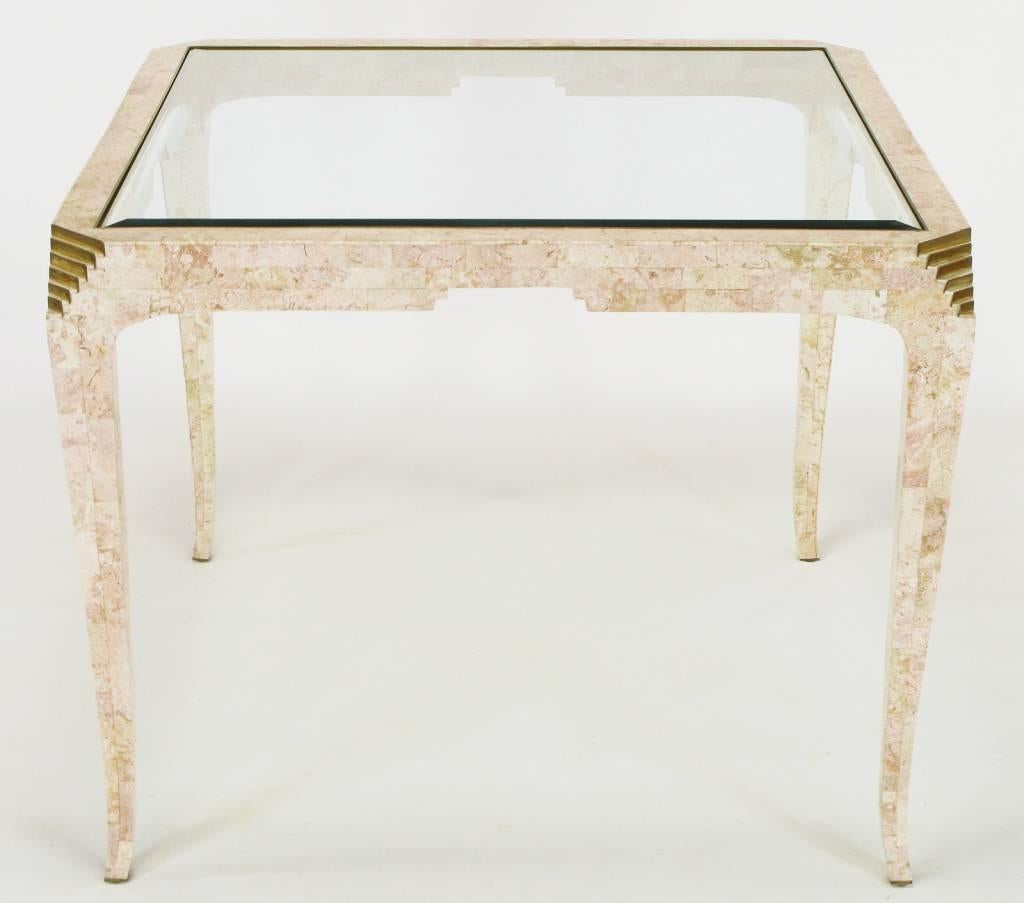Elegant and well executed tessellated coral Art Deco revival game table designed by Merle Edelman for Casa Bique. Wonderful pink rouge coloring in the stone. Thin and tapered legs with stepped brass accent to the canted corners. Brass banded opening
