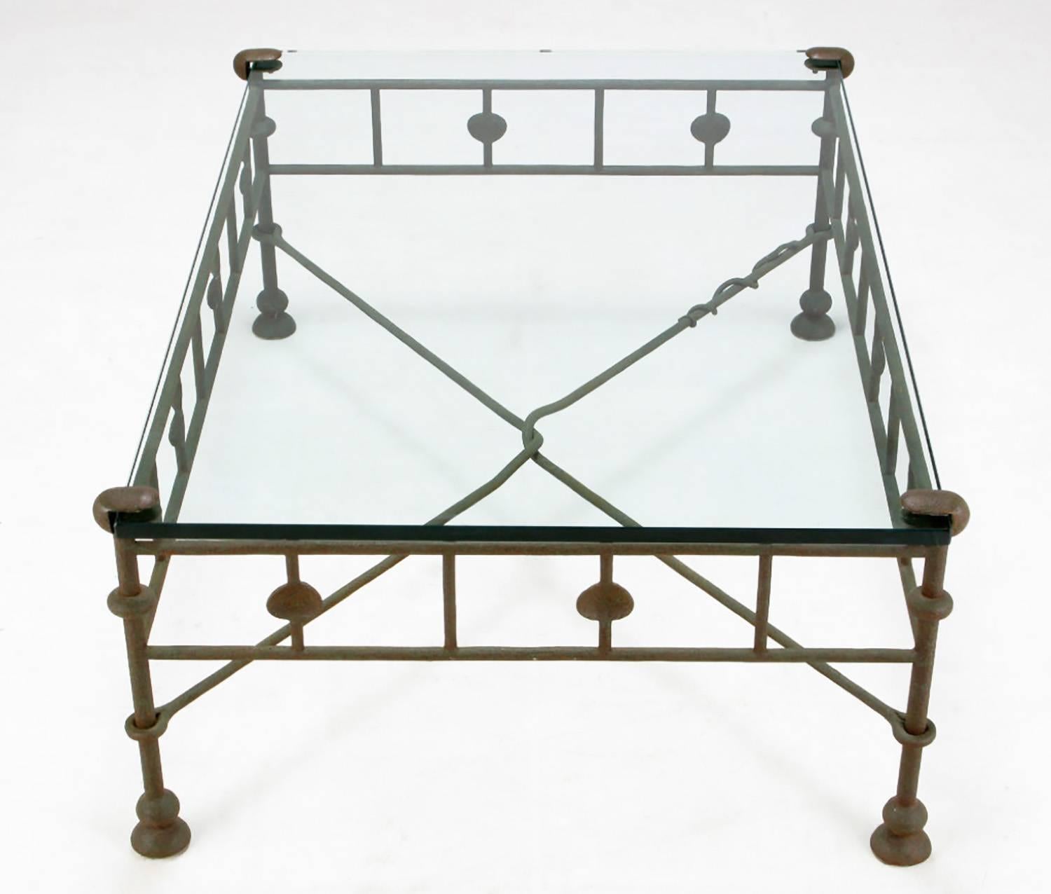 An exceptional wrought iron coffee table inspired by Diego Giacometti. The natural patina is perfect, not too oxidized and not too polished. The form and craftsmanship is very much like the work of Giacometti right down the snake wrapped around the