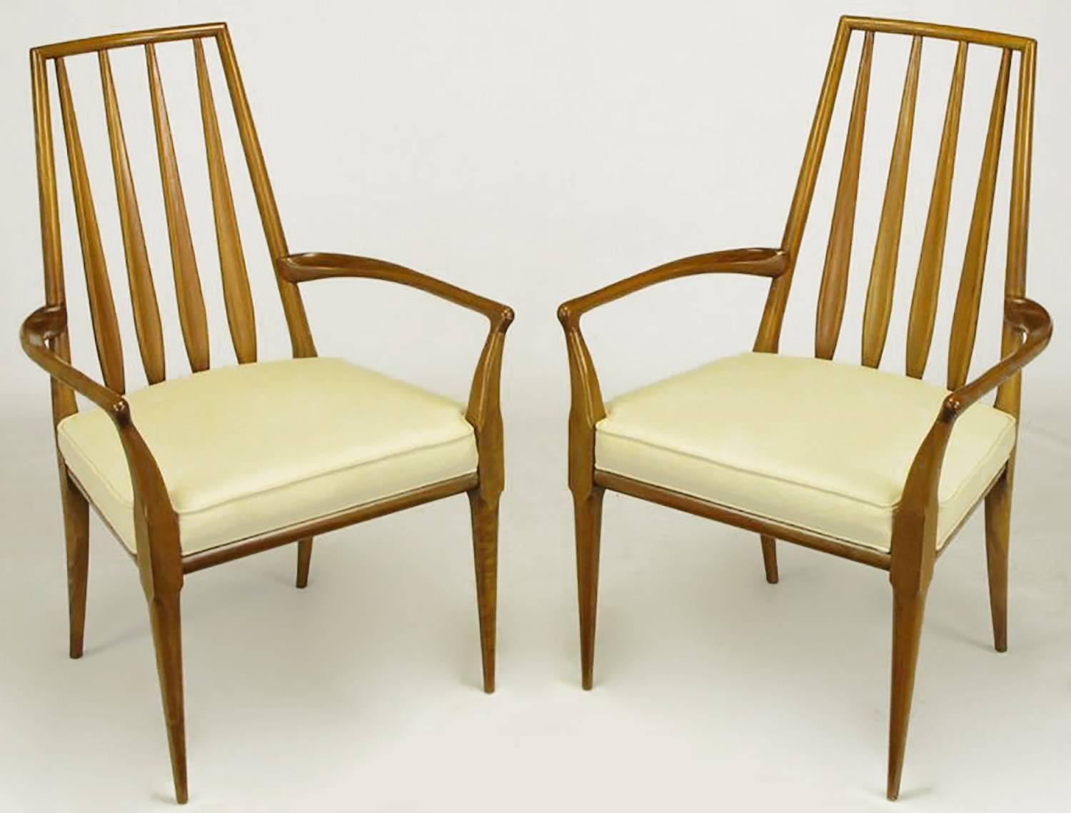 Pair of Bert England for Johnson Furniture sculpted walnut and off-white linen upholstered arm chairs. Splayed arm supports are rounded and then square up at the seats while rounding again into Fine tapered legs. The paddle slat backs create an