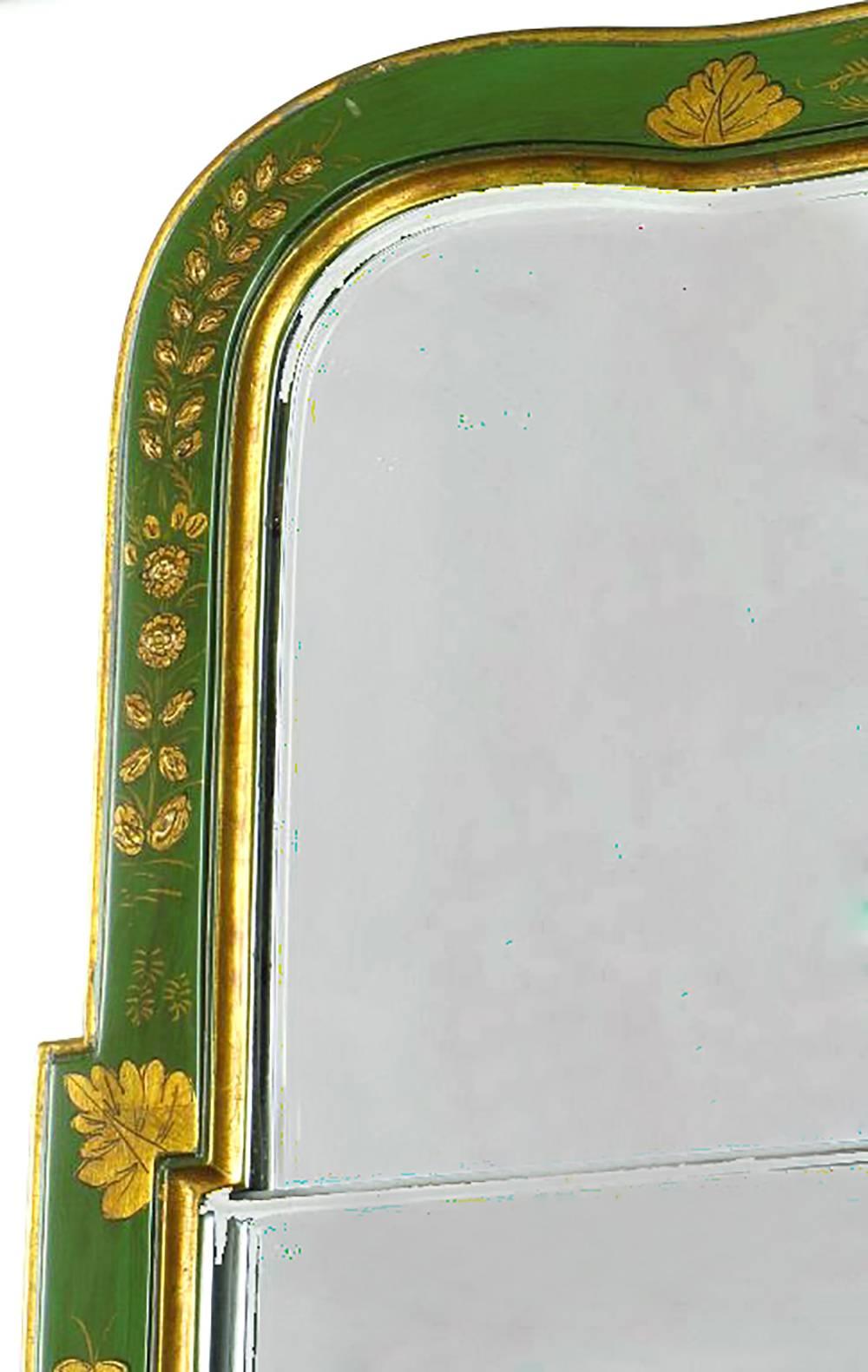 Authorized by the Colonial Williamsburg Foundation and crafted by Friedman Brothers, fine mirror maker to the trade, this classic two-piece mirror in an emerald green lacquered wood frame with gilt Chinese characters, foliage and borders.