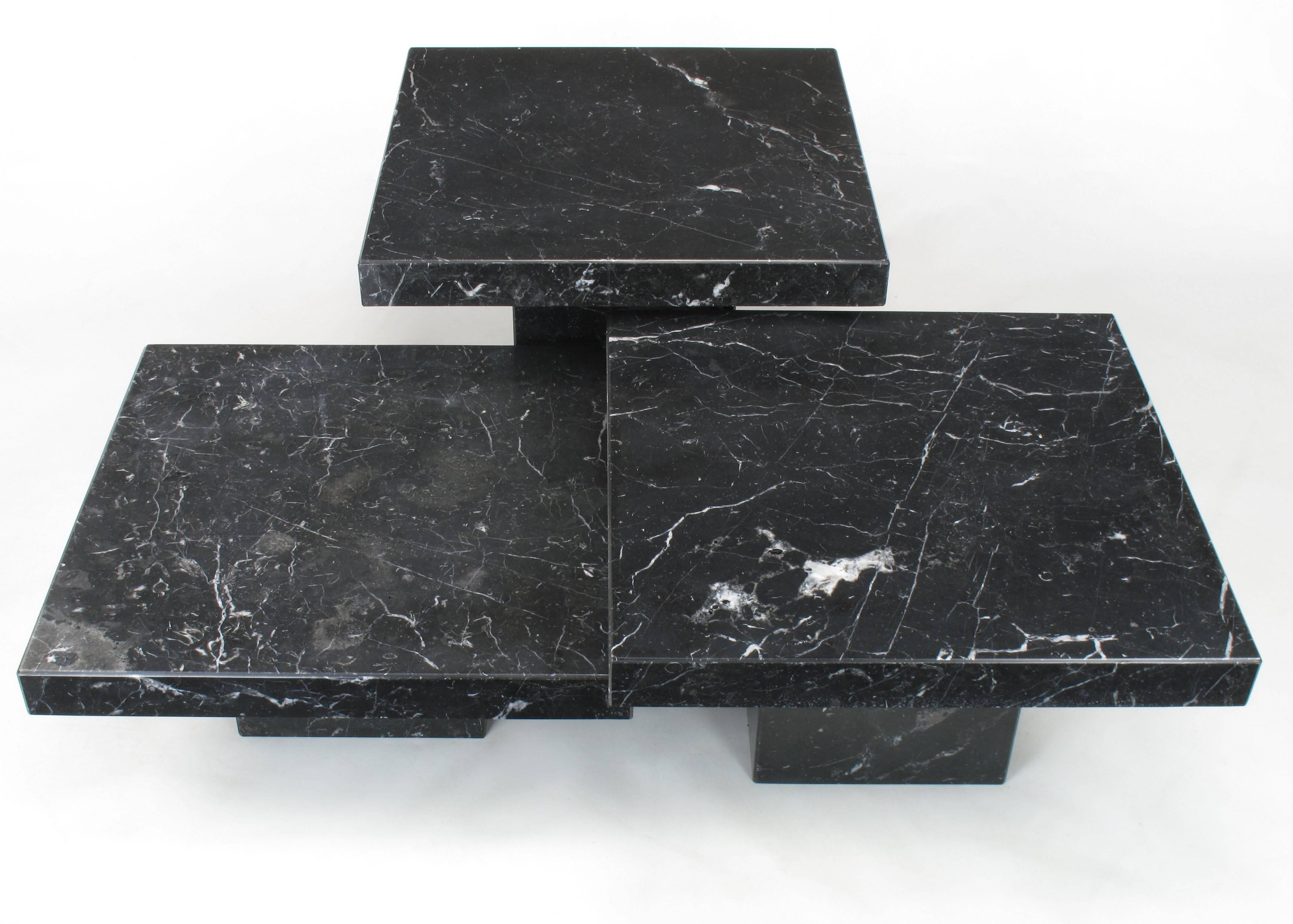 Collection of three black Nero Marquina marble low tables by Stone International S.P.A, Florence, Italy. Versatile set that can be arranged in multiple configurations from a trio of coffee tables to a set of ascending sofa tables. Measures: Heights