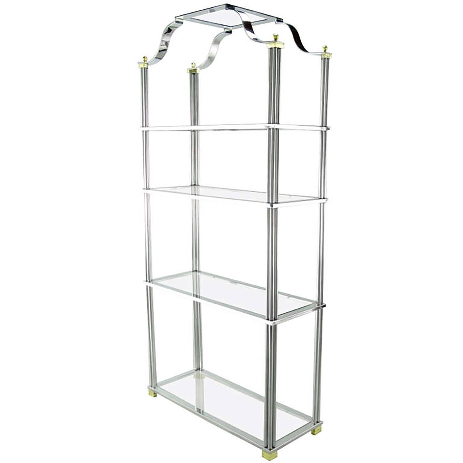 Chrome and brass four shelf ètagerè with excellent understated details. Each shelf is supported by 12 chromed bars with brass ferrules. The open chromed canopy is attached to the brass cornered top supports with four brass ball finials. The feet are