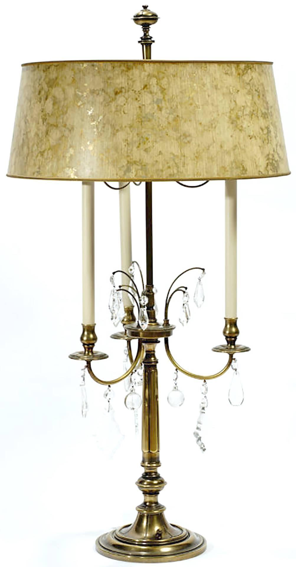 In excellent original condition, these sizable three-arm lamps are made of brass, with hanging crystals. With original cream and gold tortoiseshell shades, and stately finials.