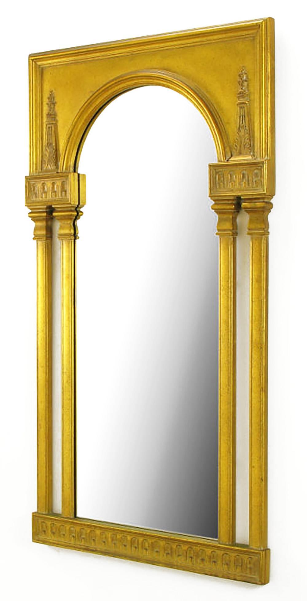 Featuring an arched-top central mirror flanked by two columns per side, this neoclassical style mirror has interesting details. Beneath the mirror, and above the columns, are reliefs of an arched colonnade. Atop the upper colonnades are acanthus