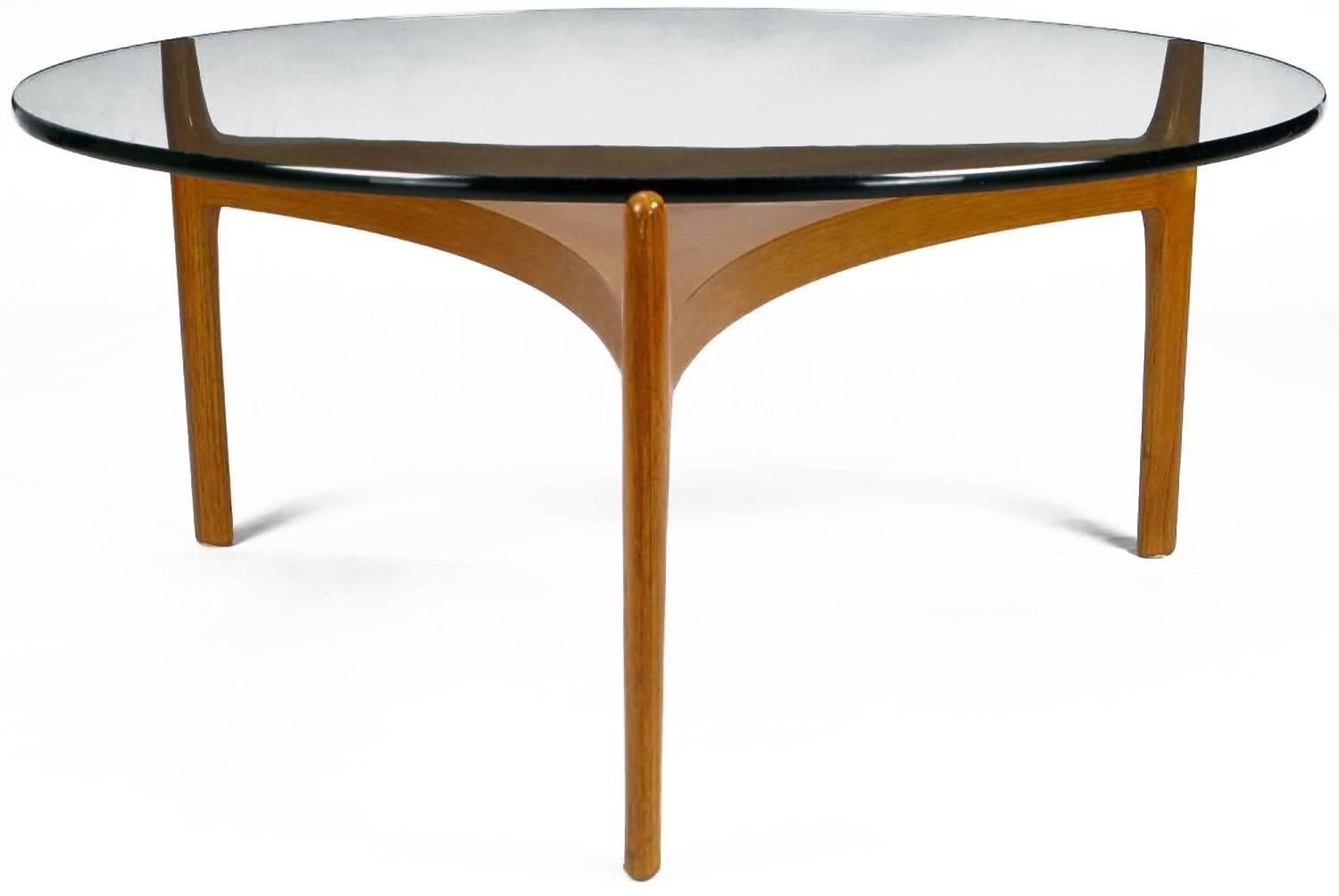 Sven Ellekaer teakwood reverse trefoil and round glass coffee table. A fine example of refined Danish design. Clean and sleek lines, bookmatched six part parquetry center. Three legs are notched at the top to secure the 1/2