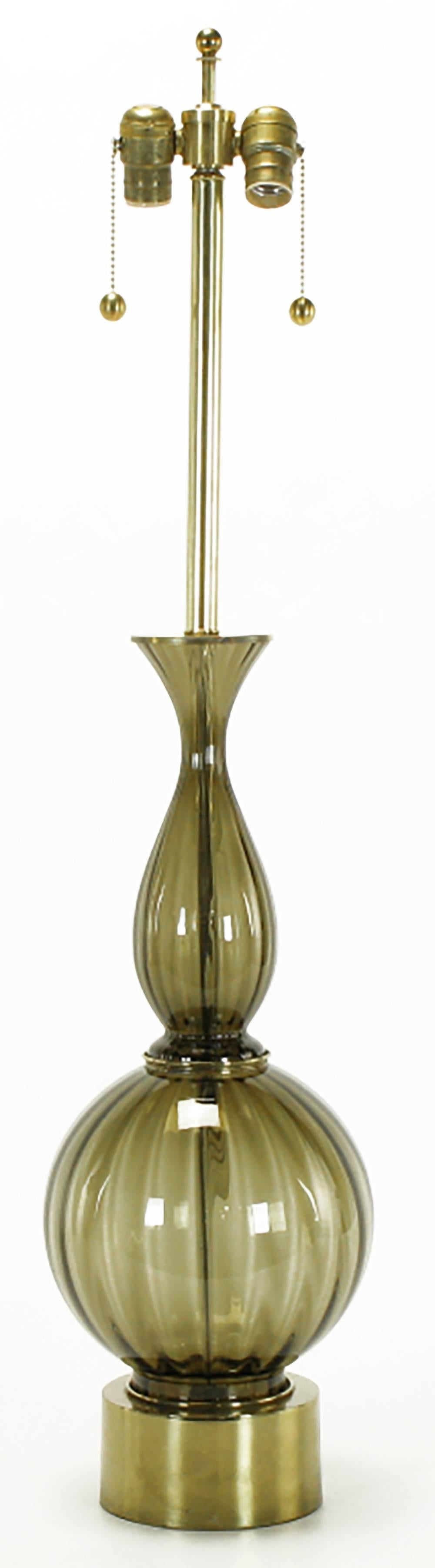 Excellent fluted and smoked Murano glass sinuous table lamp. Brass pedestal base with fluted ball brass disc spacer and vase shaped top. Brass stem and double socket cluster. Sold sans shade.