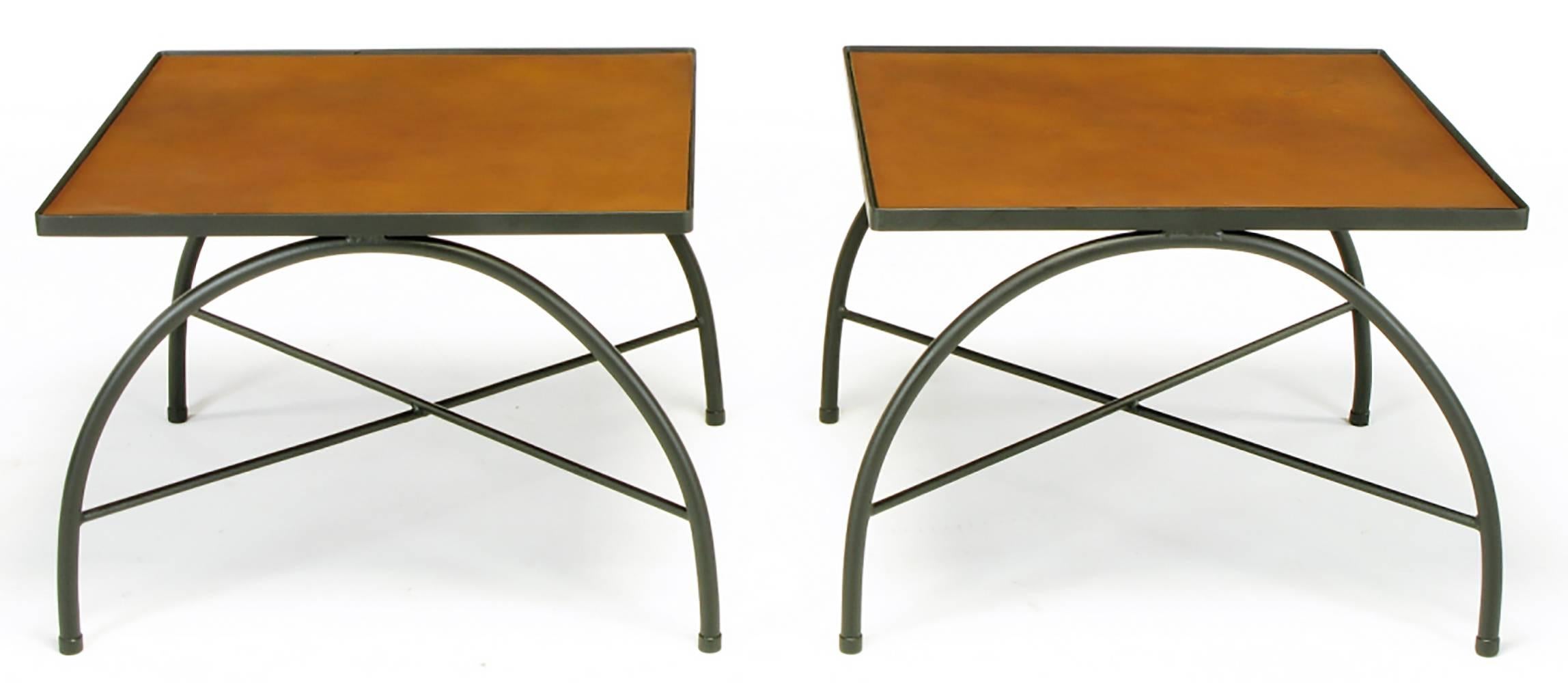 Pair of custom wrought iron side tables with X-stretcher bases and curule legs in the style of Jacques Adnet. Square top has a leather covered Masonite board inladed into a wrought iron frame. Custom-made for a Chicago area estate in 1966. Two pair