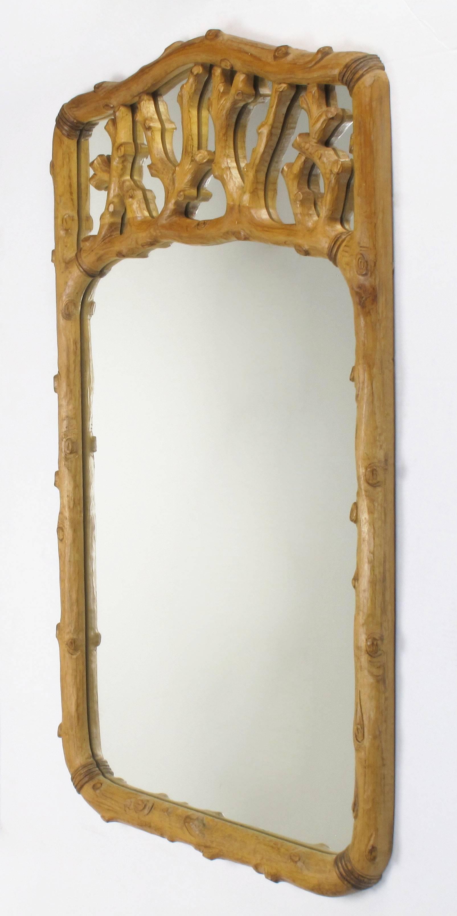 Exceptional hand-carved solid fruitwood faux bois mirror with pierced top. Radiused on all corners, with carved appointments to resemble raw hide banding. Very organic in form. Measures: 53