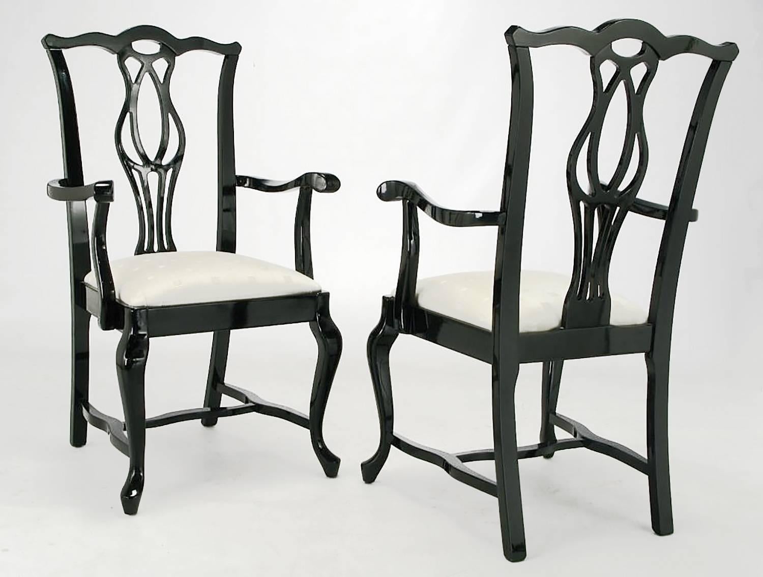 Set of six Chinese Chippendale style black lacquer over hard wood dining chairs with off white silk blend upholstered seats. Set includes two armchairs and four side chairs. Excellent carving from the sinuous stretchers to the cabriole front legs to