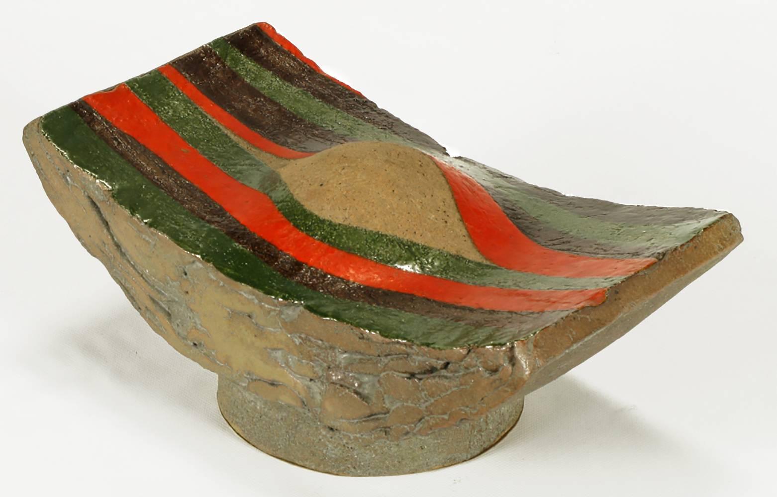 Glazed terra cotta abstract modern sculpture by Tomiya Matsuda. Brown, green and cinnabar glaze over a layered terra cotta curved and footed form with bulbous center. Tomiya Matsuda (1939-2011) studied at the Kyoto University during the late 1950s