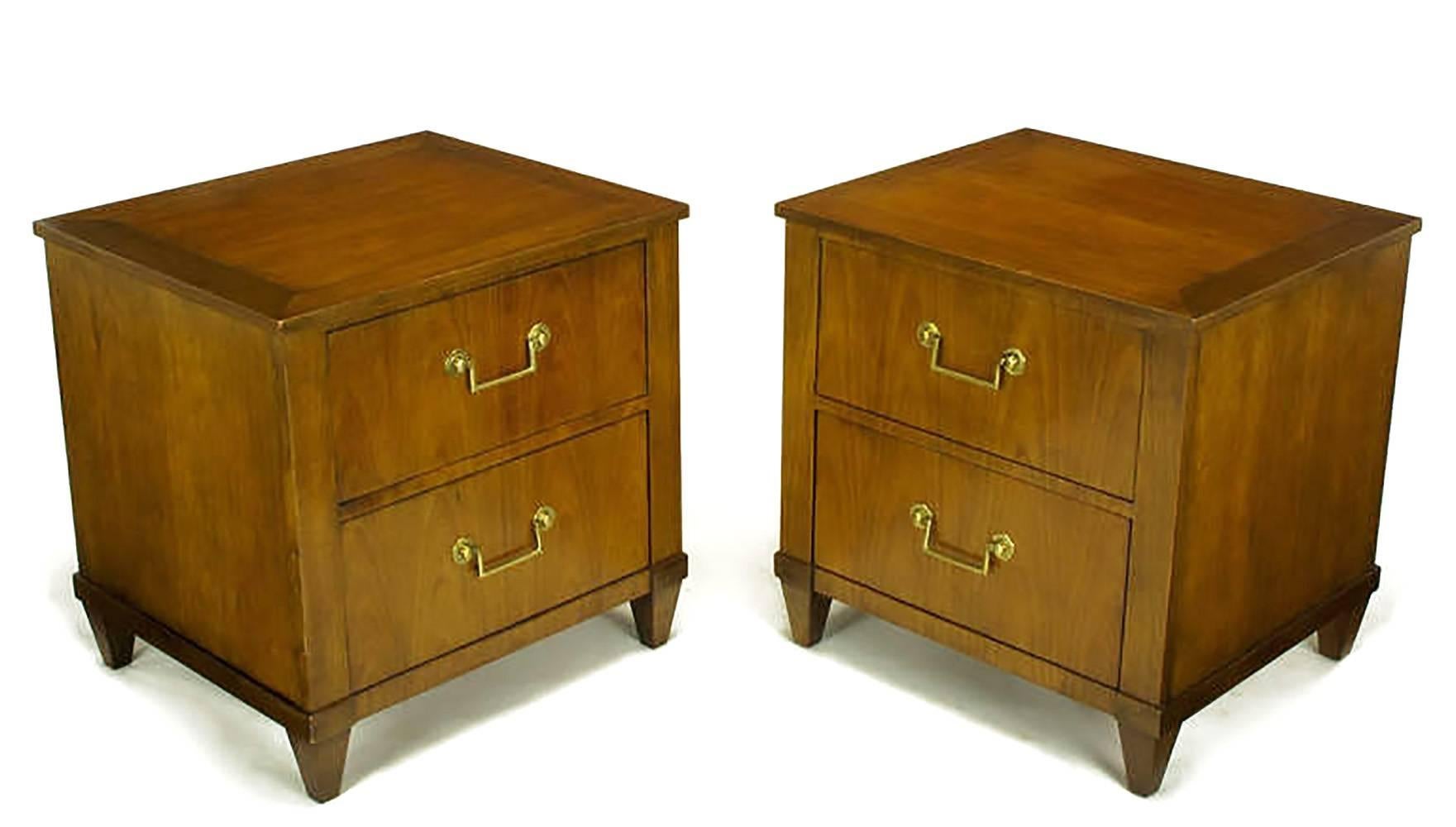 Unusual pair of Baker nightstands in figured French cherry, with brass bail drop pulls and round escutcheons. Transitional style with a single drawer and a fall front storage space above. Could also be used as end tables as they are finished on all