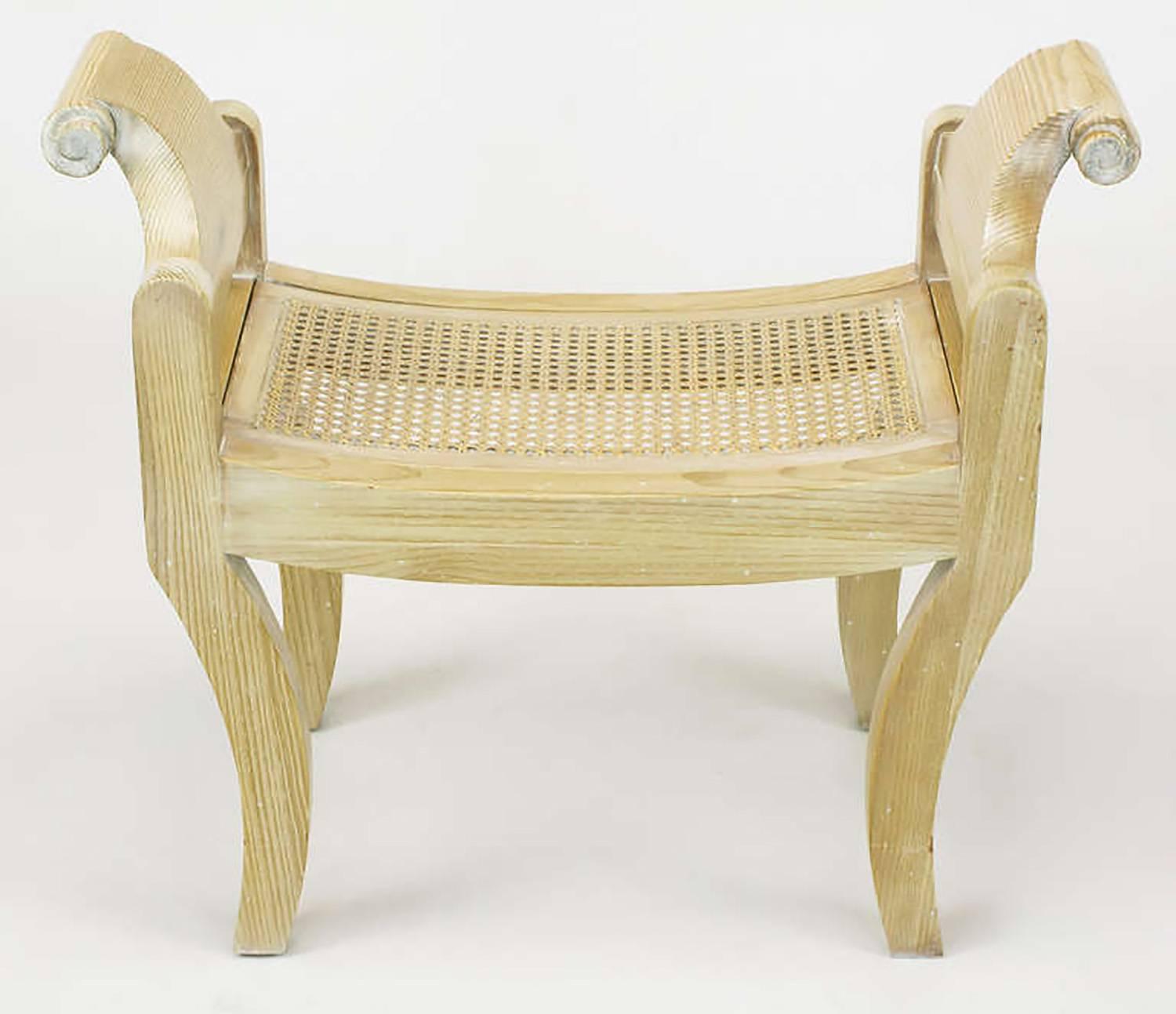 Pair of Swedish Rococo style pine benches with klismos form legs, scrolled arm handles and curved cane seats. Constructed from white pine, glazed in white and restored with patina left intact.