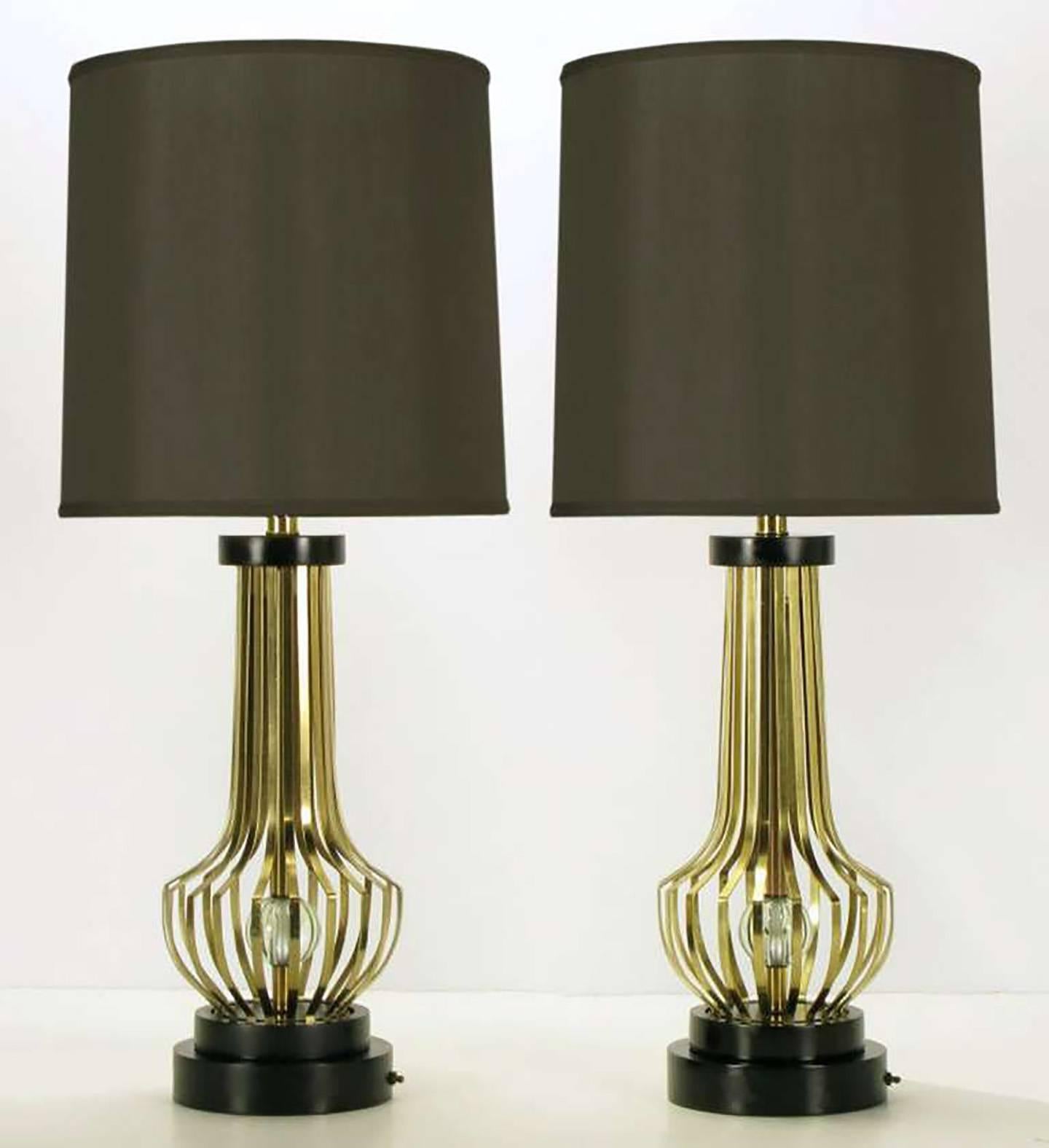 Pair of vase form open rib table lamps with internal crystal spheres. Black lacquered and stepped round disc bases with switch and black lacquered disc cap. Original milk glass diffusers on large brass cups. Unmarked, but milk glass diffuser and