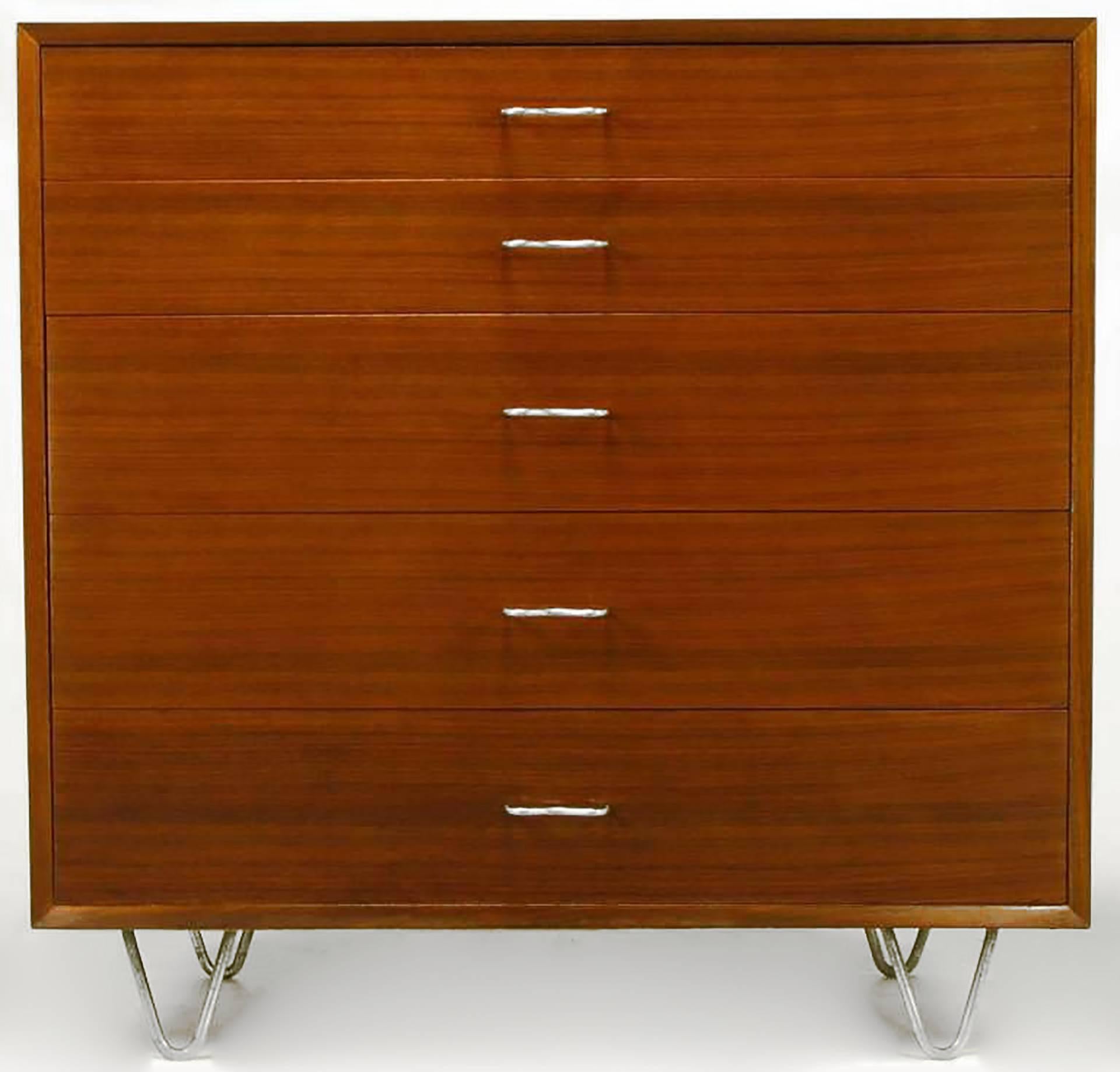 Ribbon mahogany five-drawer dresser by George Nelson for Herman Miller. M-shaped aluminium pulls and hair pin aluminium legs. Top drawer is partitioned as is the third deeper drawer.