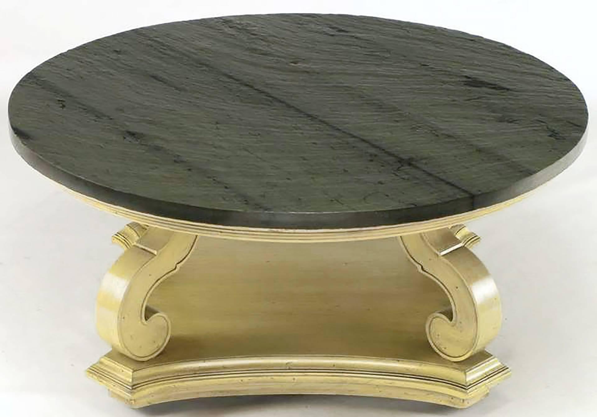A Dorothy Draper design from her iconic Espana collection, this exceptional Heritage Henredon round coffee table is comprised of hand-carved wood with an ivory glaze. Reverse quatrefoil, canted corner base is on casters for ease in movement. Natural