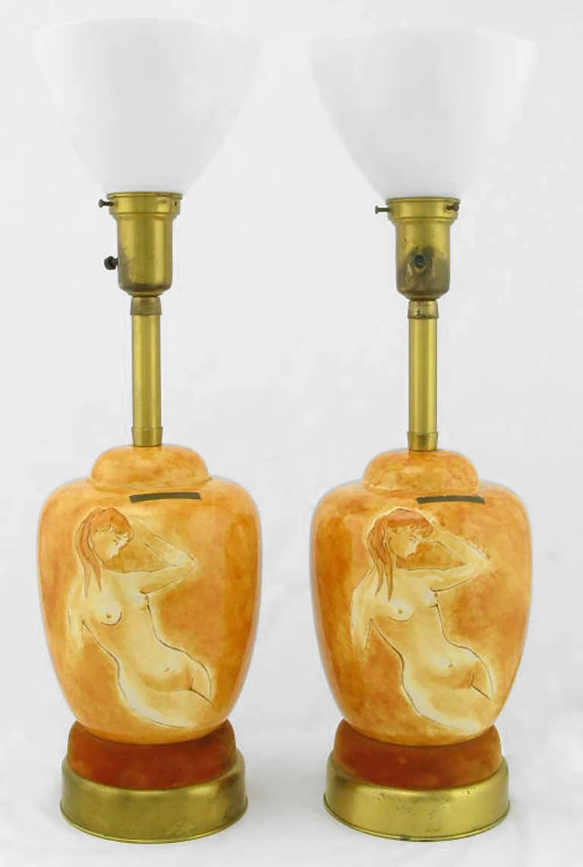 Pair of Sèvres Porcelain hand-painted table lamps with two part brass and umber velvet base. The hand-painted and glazed bodies of the table lamps are a female nude on a heathered cinnamon background. Comes with original milk glass diffusers. Sold