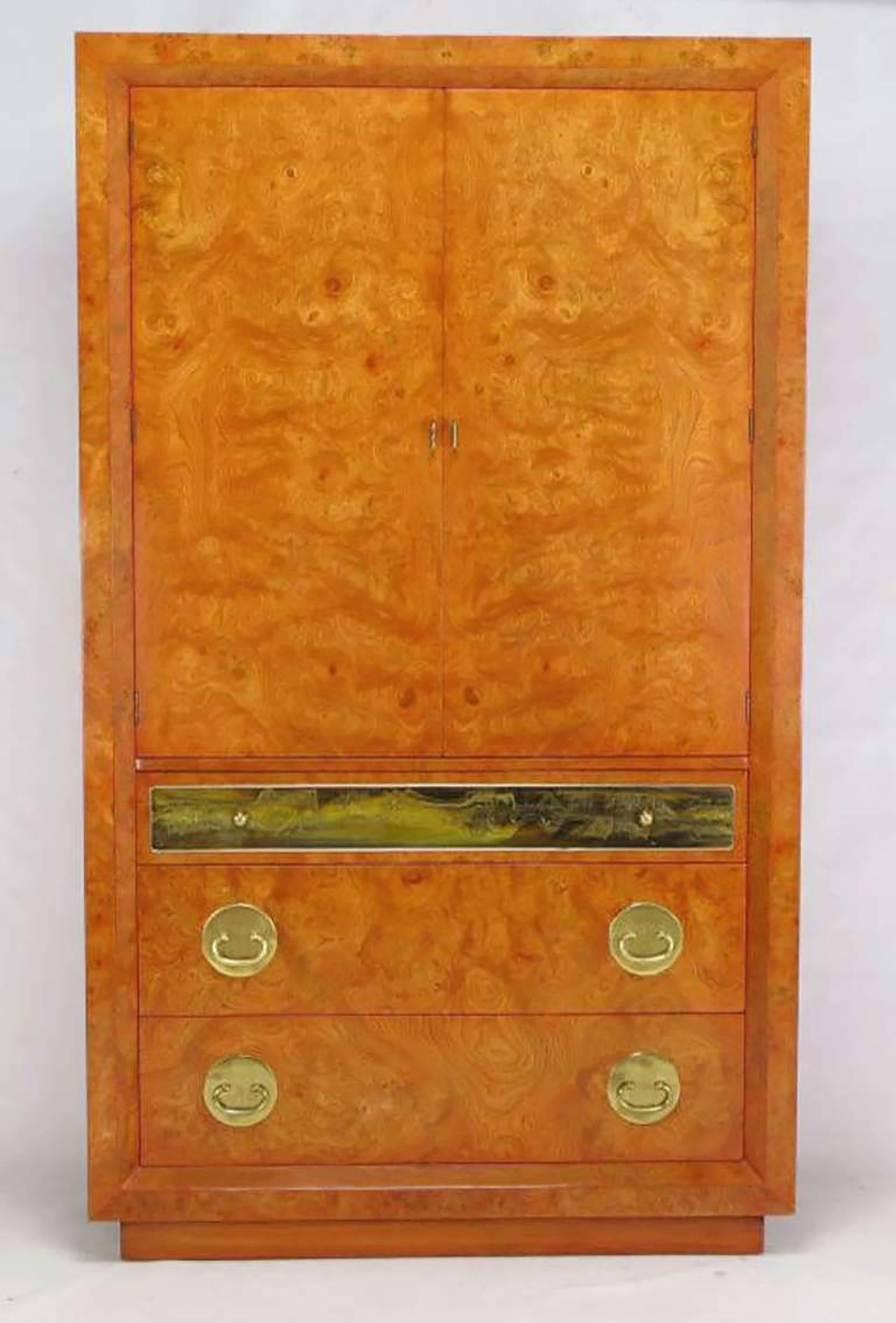 An unusual and rare Mastercraft tangerine stained tall wardrobe cabinet, or armoire. Three drawers in the base with the four top drawer having an acid etched panel by Bernhard Rohne. The upper compartment is fronted by two doors, and offers storage