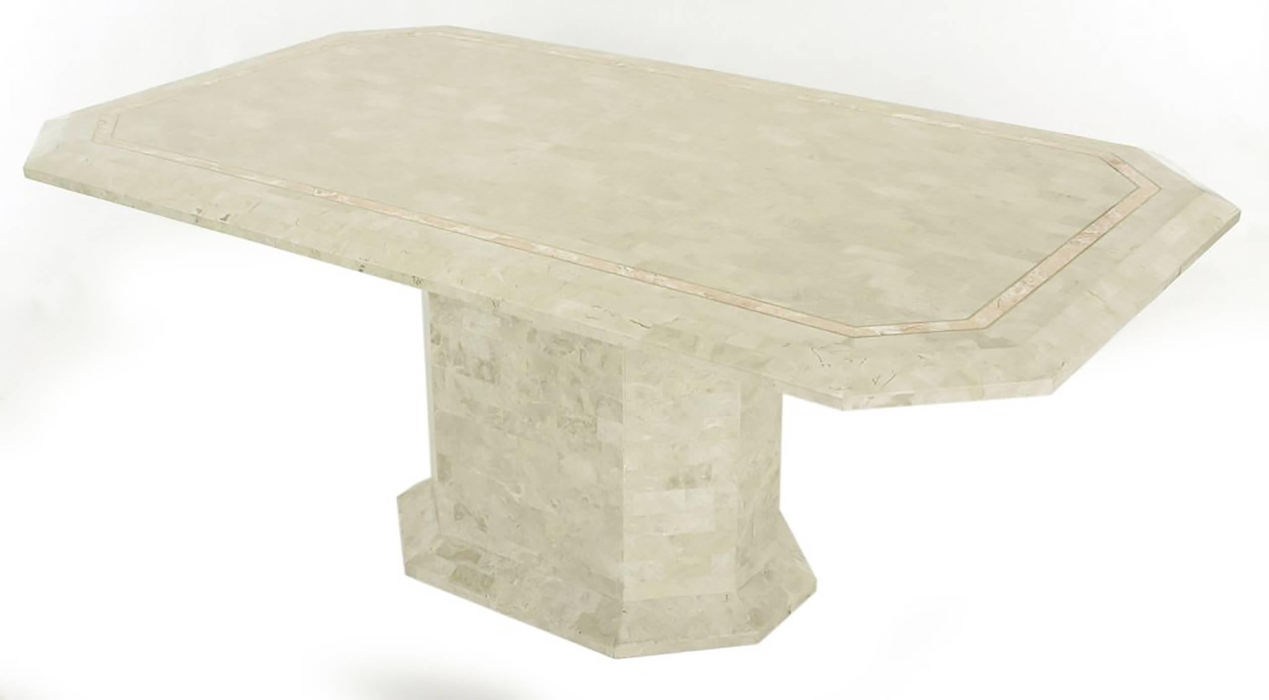 Tessellated fossil stone over wood Art Deco Revival pedestal table with rouge marble and brass inlaid border. Elongated octagon with form following pedestal base. Designed by Robert Marcius and marketed by Casa Bique. Manufactured in the