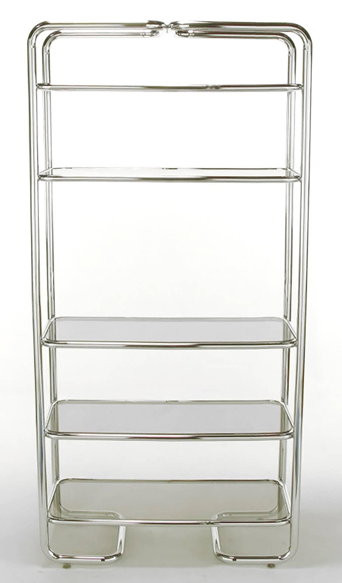 Soft rounded corners and chromed tubular steel étagère in the manner of John Mascheroni. Five shelves with inset smoked glass. Unusual return sled base.