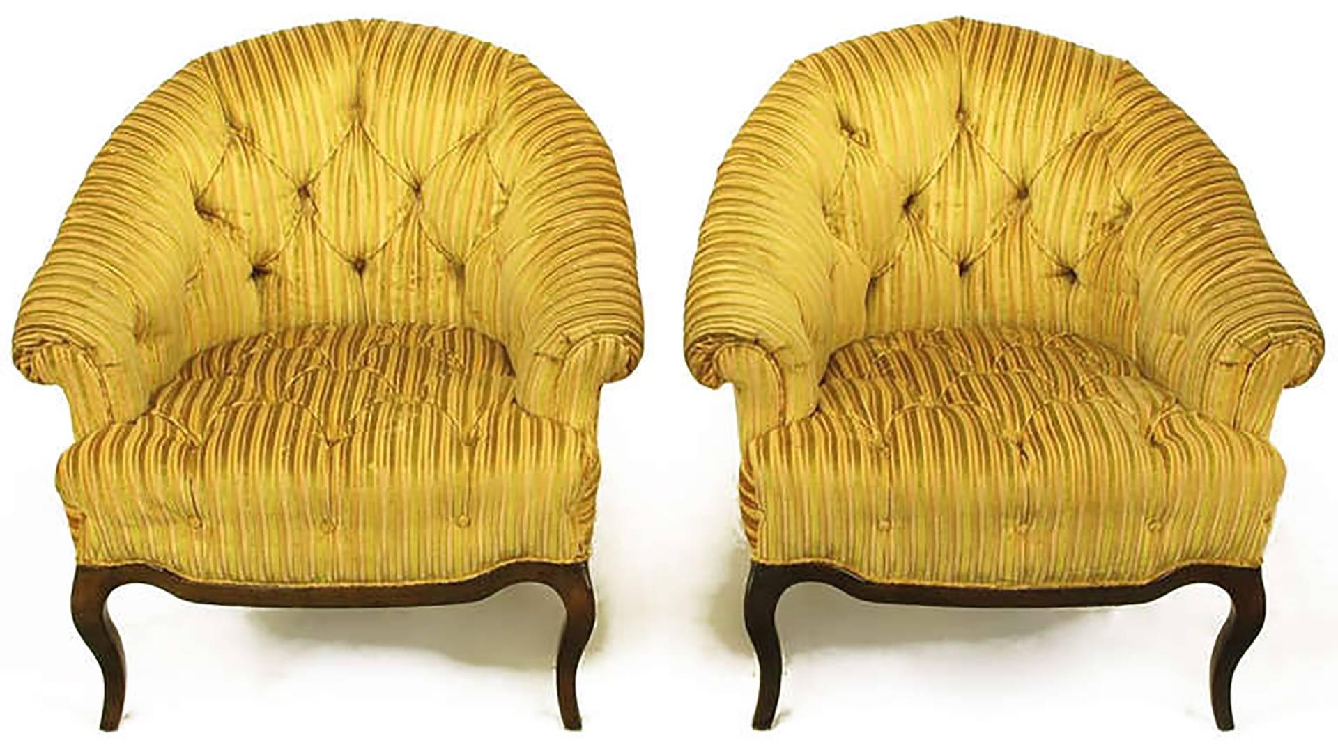 Pair of button tufted, cut and striped gold velvet lounge chairs with rolled sloping arms and barrel back by Interior Crafts, Chicago custom furniture manufacturer to the trade. Carved walnut cabriole legs with scalloped walnut apron. Among others,