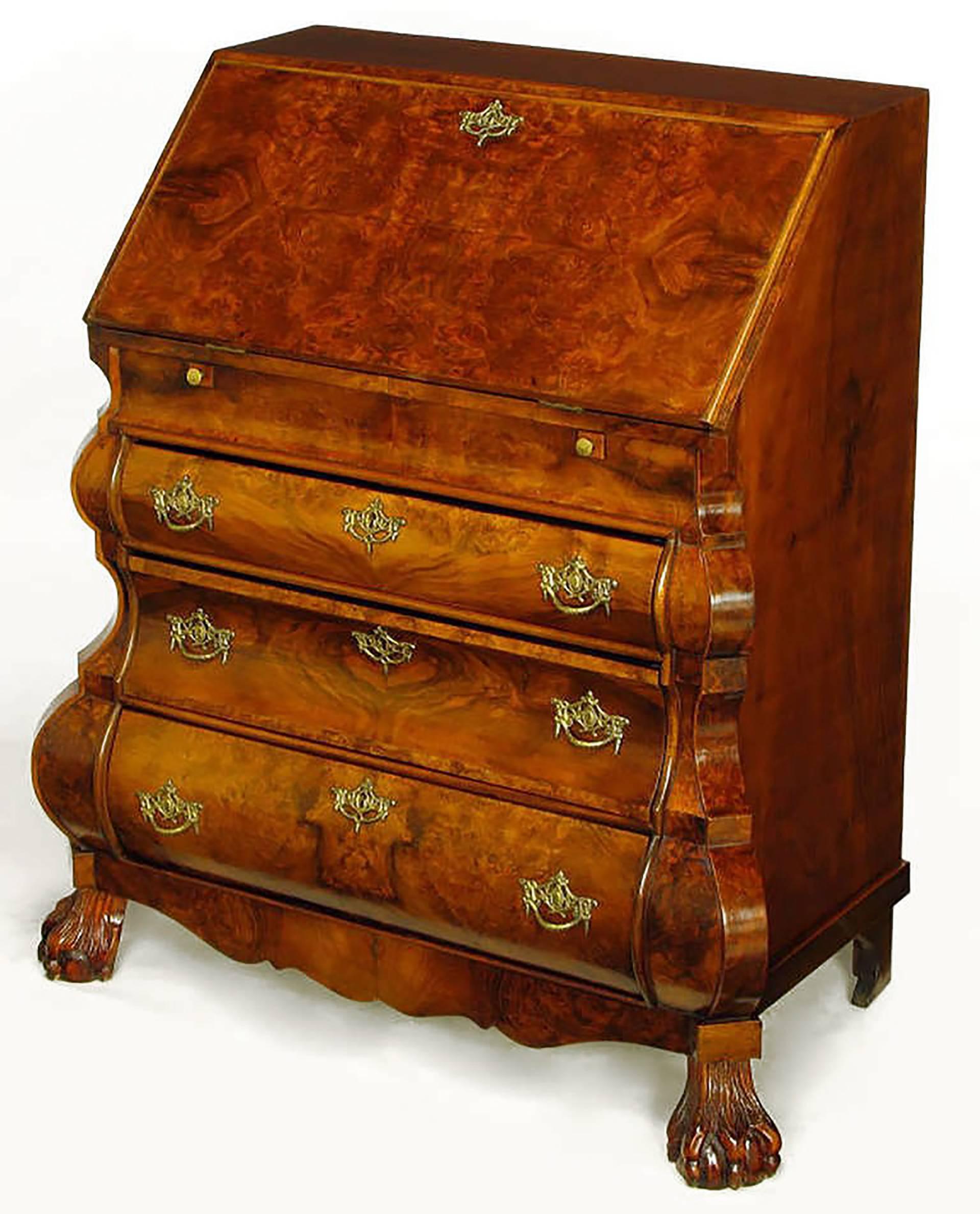 Dutch Rococo style burled walnut bombe front secretaire with carved ball and claw feet. Three drawers with cast brass pulls and cast brass detailed key holes. Drop front top door opens to reveal a tooled leather writing surface and serpentine burl