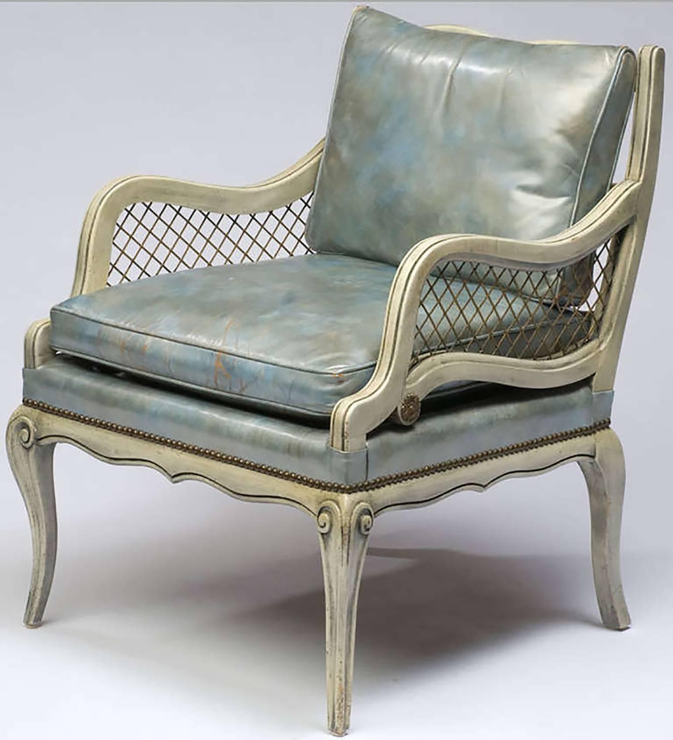 Originally purchased at Marshall Field and Company's State Street store in the 1940s, these carved wood club chairs are finished in a distressed grey glazing over white undercoat. The open-arm sections are filled with heavy brass grilles, and the