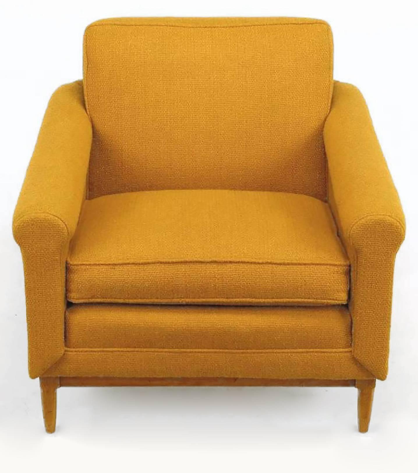 An uncommonly designed chair and ottoman in the manner of Dunbar designs by Edward Wormley. Tubular, amber upholstered arms taper and surround the back of this exceedingly comfortable club chair. Fixed back cushion is supported by an interior wood