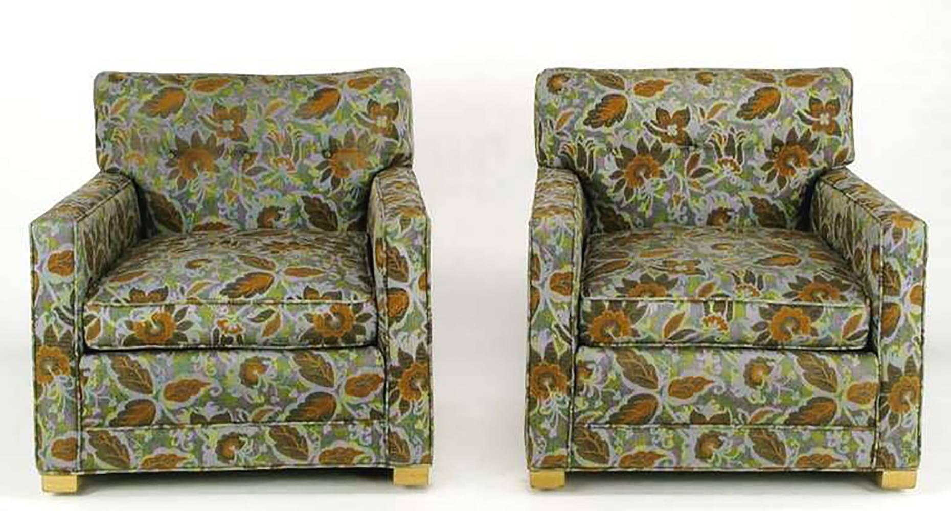 Unique sled based, button tufted, clean lined club chairs in a vivid needlepoint-like floral upholstery of greens, rust, lavender, light blue and black. Bleached mahogany parallel sled leg are substantial and characteristic of American Art Deco