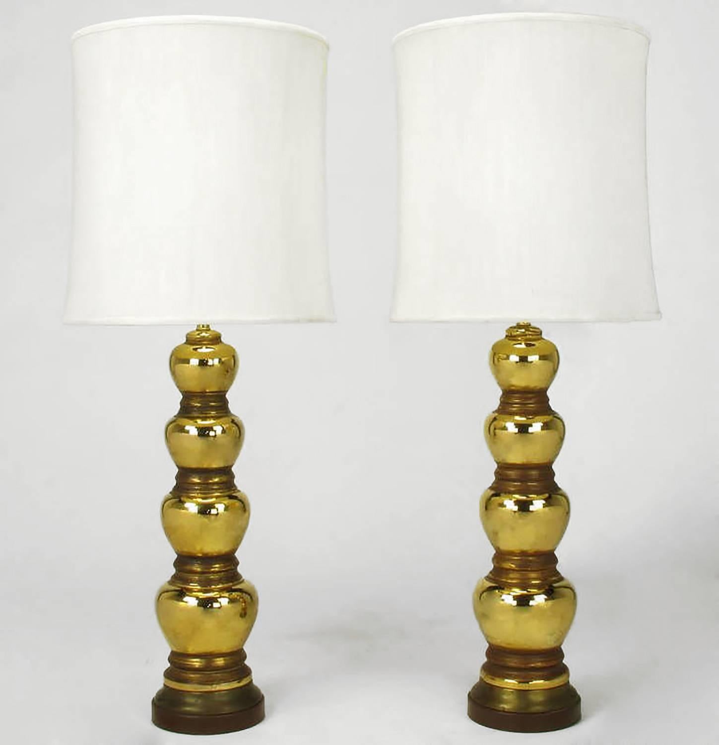 Pair of 1930s gold-plated and brown glazed porcelain quadruple gourd table lamps. Mirror like finish to each gourd with a brown semi opaque matte glaze to the spacers in between each gourd. Patinated brass and chocolate lacquered two part base. Stem