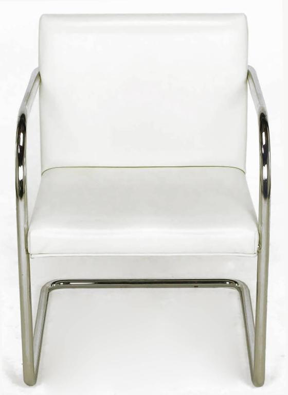 An early design of tubular chromed steel cantilevered frames, updated in this 1970s version. Single piece of tubular chromed bent steel, wood framed seat and back covered in white leather-like vinyl.