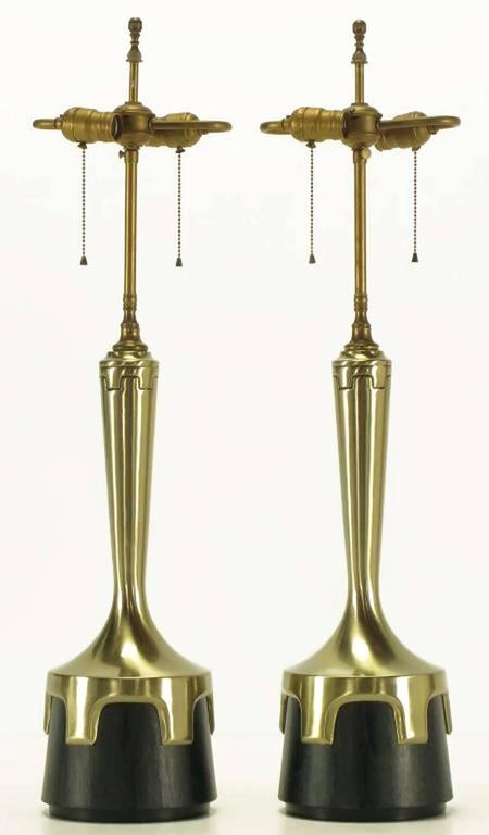 Pair of early Frederick cooper aged nickel (not brass) and ebonized walnut table lamps. Nickel-plated bodies with inverted crenellations clasping ebonized veneer bases. Incised decoration encircling the necks echoes the crenelated design. Double