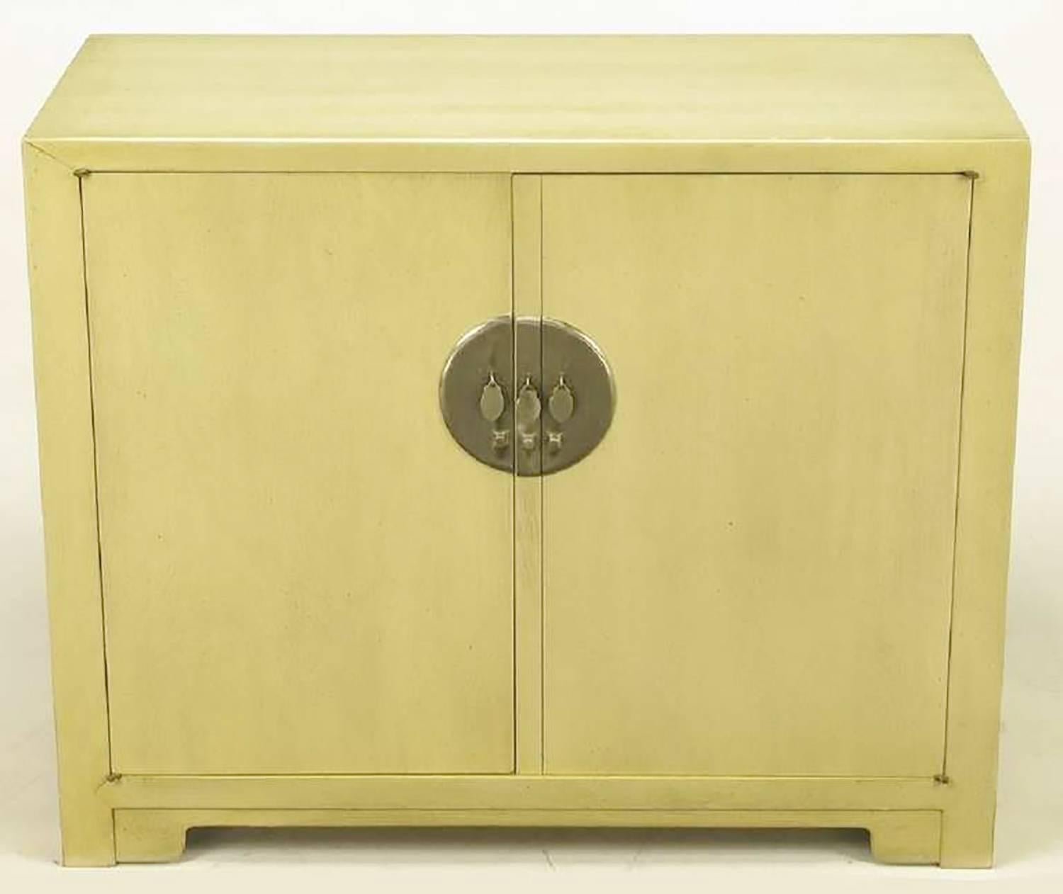 Pair of Baker Asian inspired two-door cabinets, from Winsor White's Far East Collection. One cabinet features three drawers and the other has open shelf storage. Large round nickel escutcheons and drop disc pulls are exceptional. Bases feature