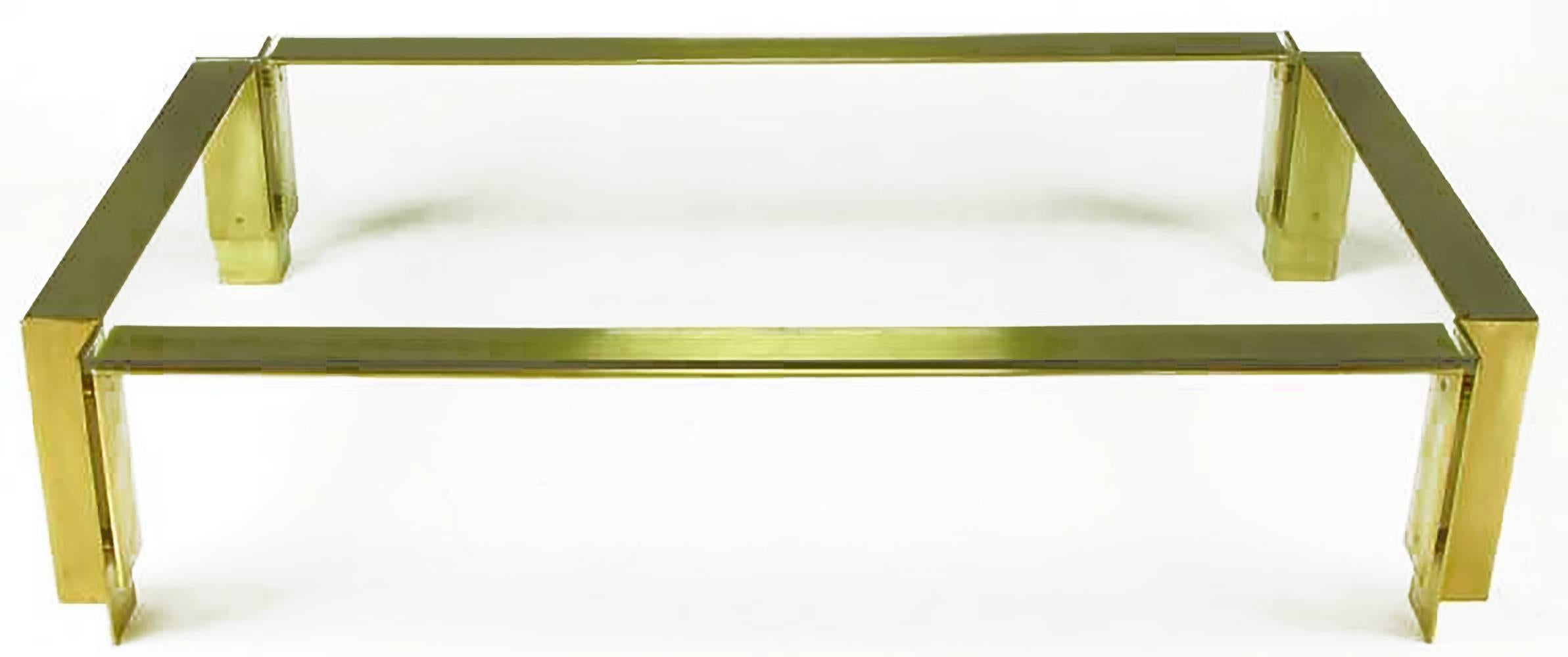 Architecturally inspired Postmodern coffee table constructed of solid brushed brass inward angle legs and floating U-shaped flat bar supports. Well made and heavy, with half-inch thick excised corners glass top. From an estate with many custom items