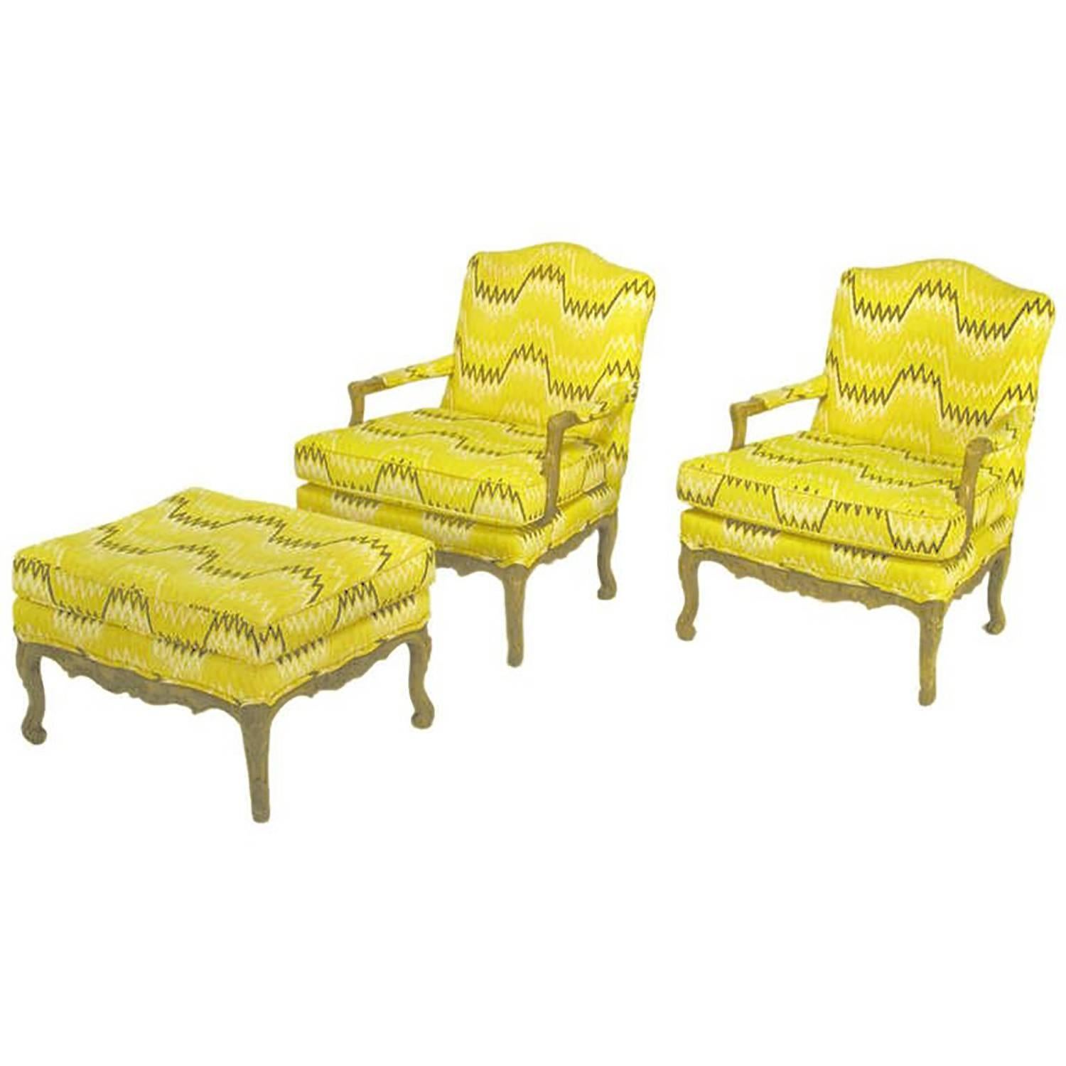 Pair of Louis XV fauteuils with matching ottoman in a auerolin yellow, black and white geometric flame stitch linen upholstery. Carved wood frames have been lacquered and antiqued to resemble an aged light fruitwood.
Ottoman measures; H 19