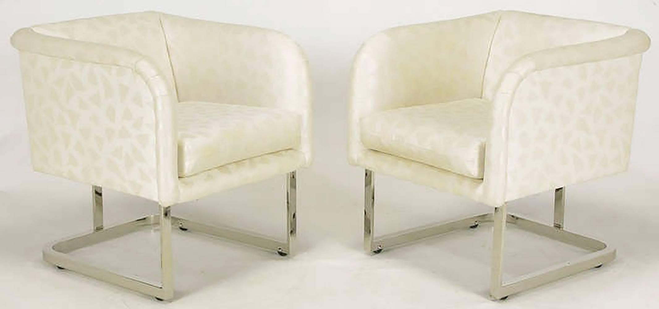 Pair of Milo Baughman for Thayer Coggin soft cube form club chairs. Nickel over steel base has the appearance being cantilevered yet with the addition curved center support and integral casters. Loose seat cushion and slightly rolled arms and back