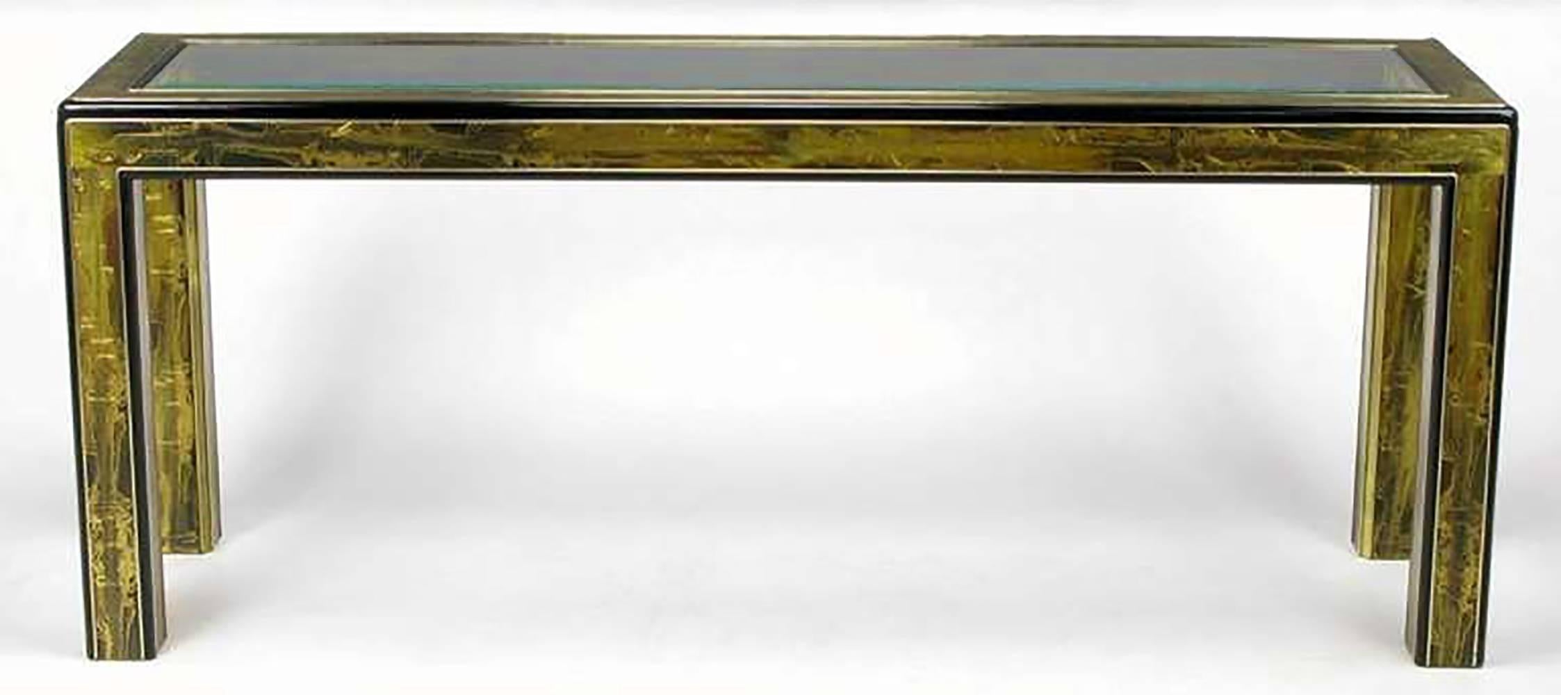 Acid etched panels by noted metal artist Bernhard Rohne cover nearly every flat surface of this black lacquered, radius edged Parsons console table from Mastercraft. Beveled center glass panel top.