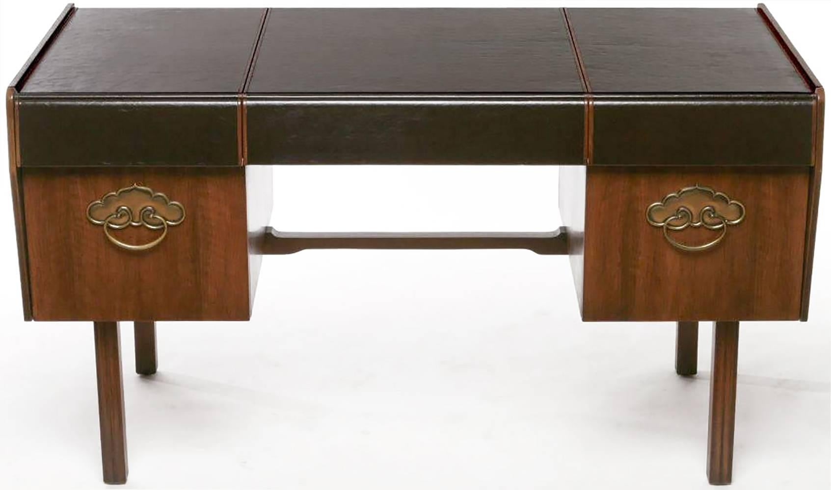 From California designer Bert England's Orientation Group for John Widdicomb Company, this extraordinary desk is made of Persian walnut and solid mahogany. 

Wrapping around the front and back, including upper drawer fronts, the black leather top
