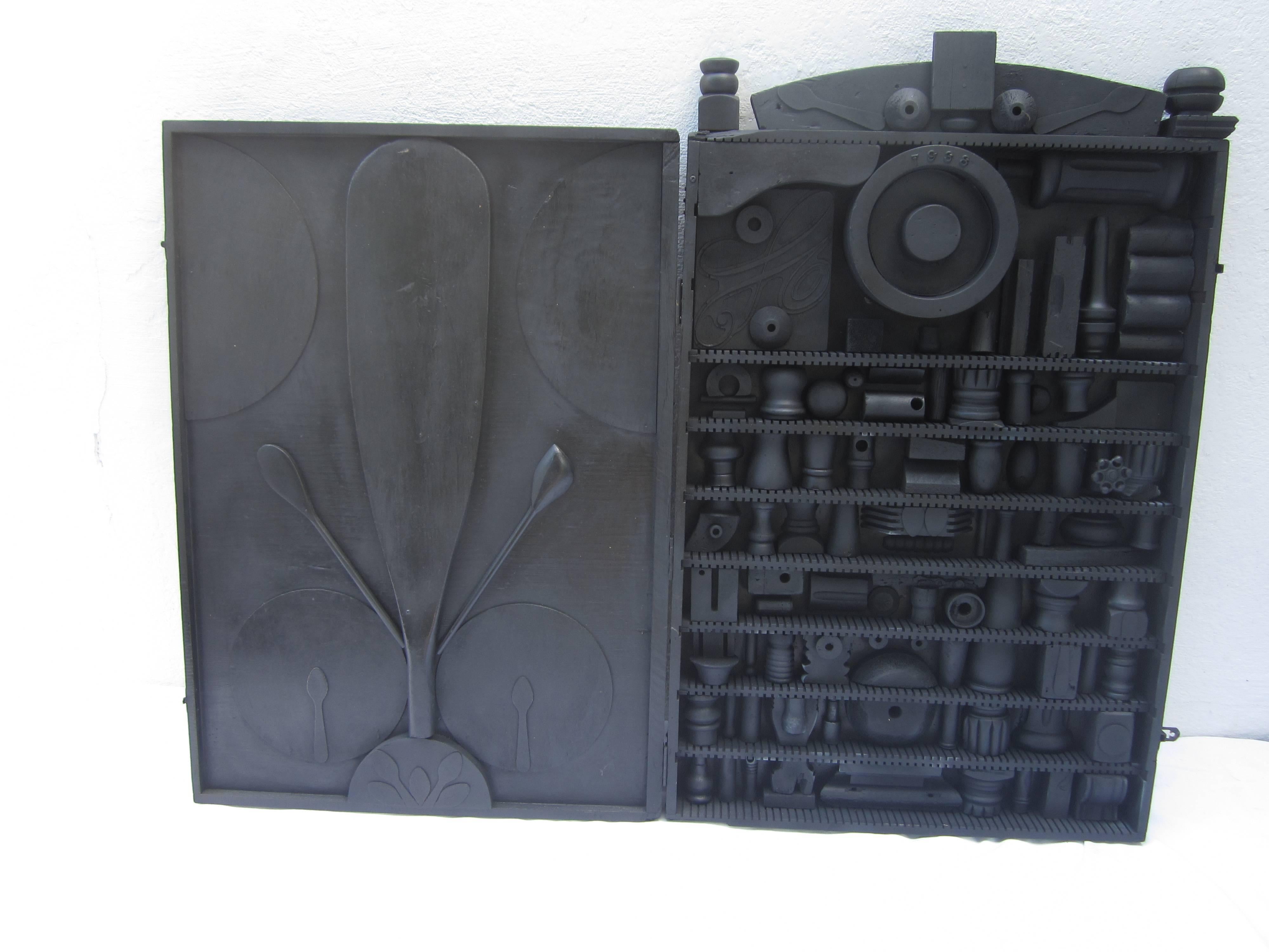 Black painted cabinet reminiscent of Louise Nevelson.