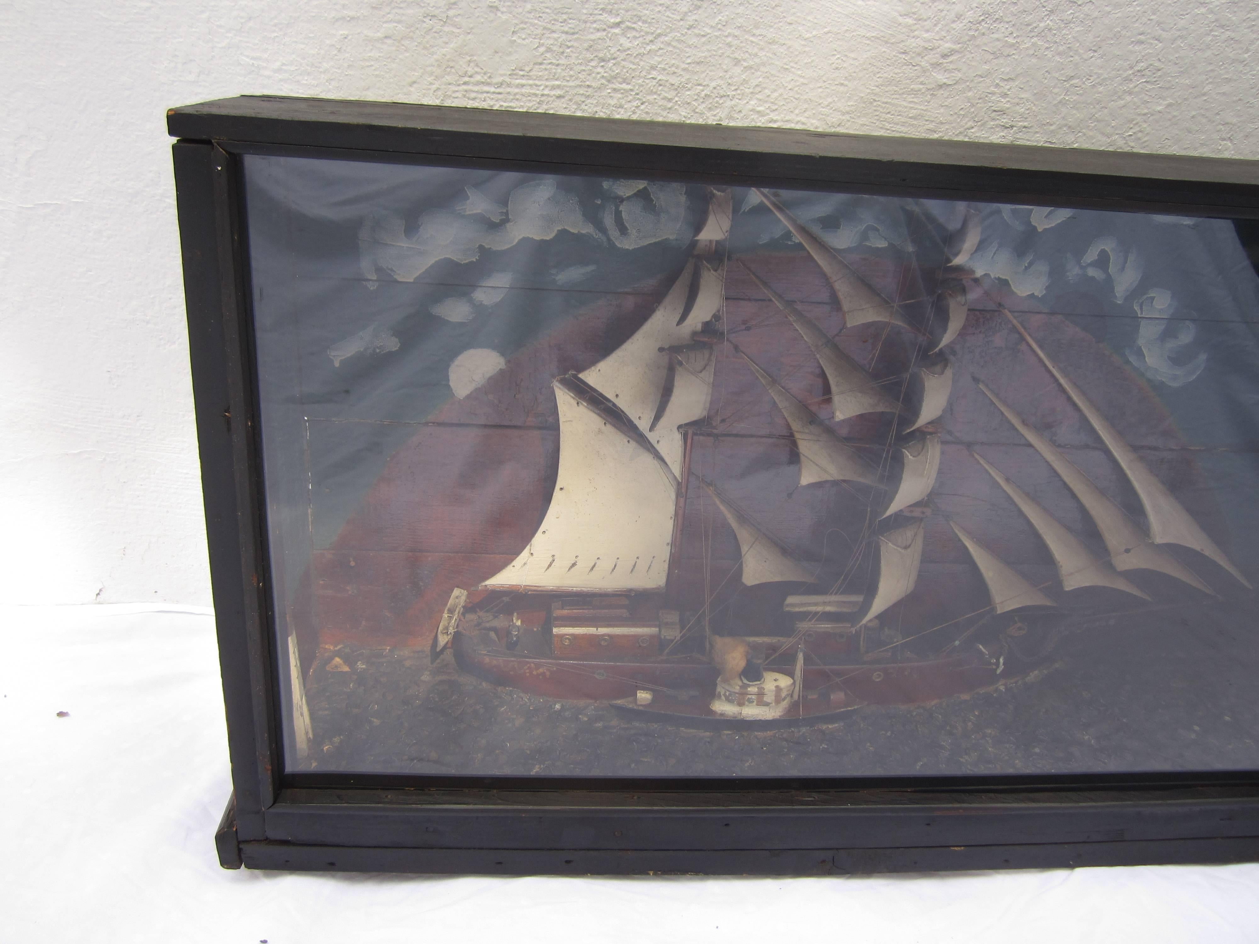 Shadow box with a ship model.