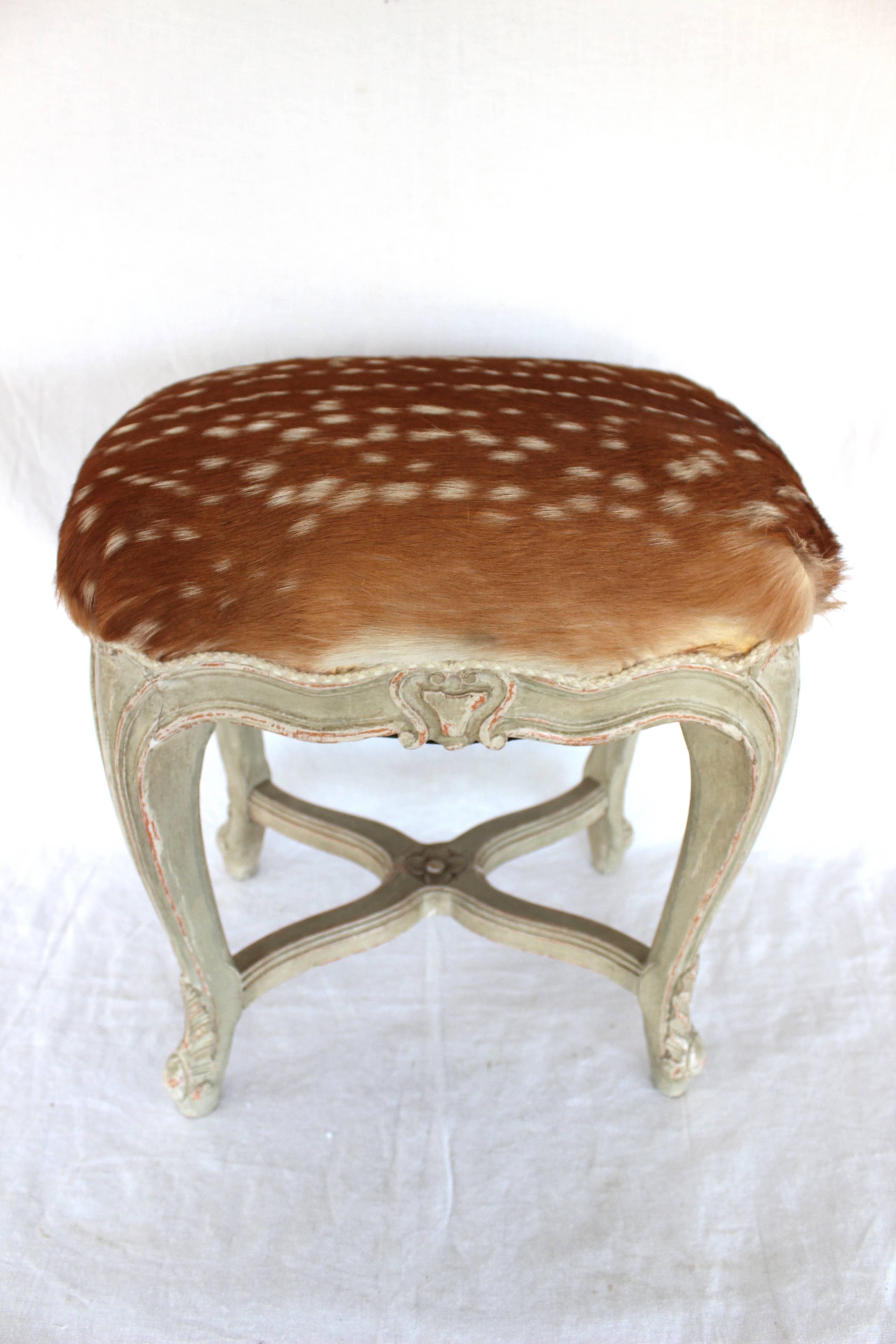 Very elegant Louis XV style stool with deer skin upholstery and Samuel and Sons braided trim.