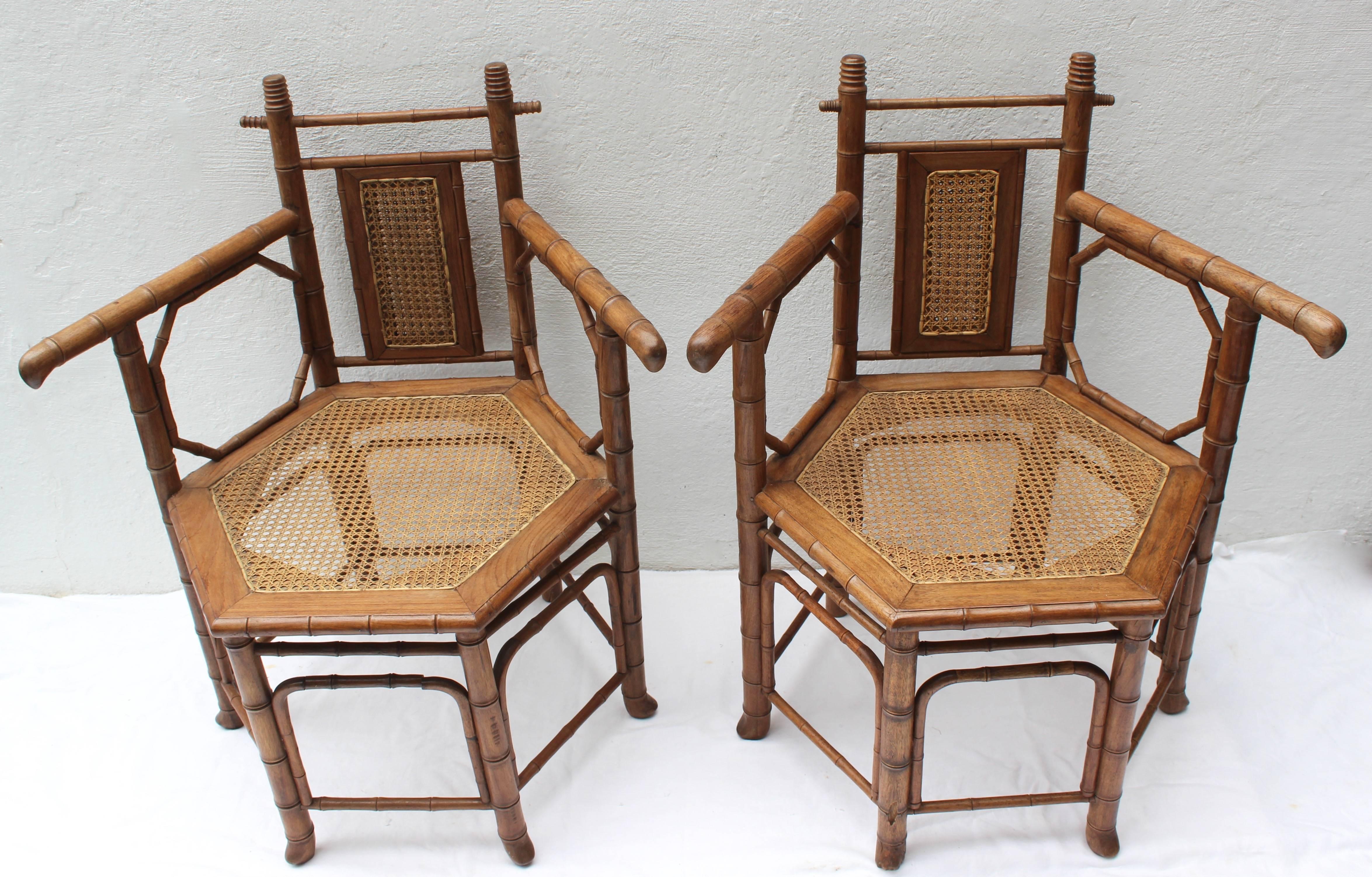 Pair of hexagonal faux bamboo and cane arm chairs.