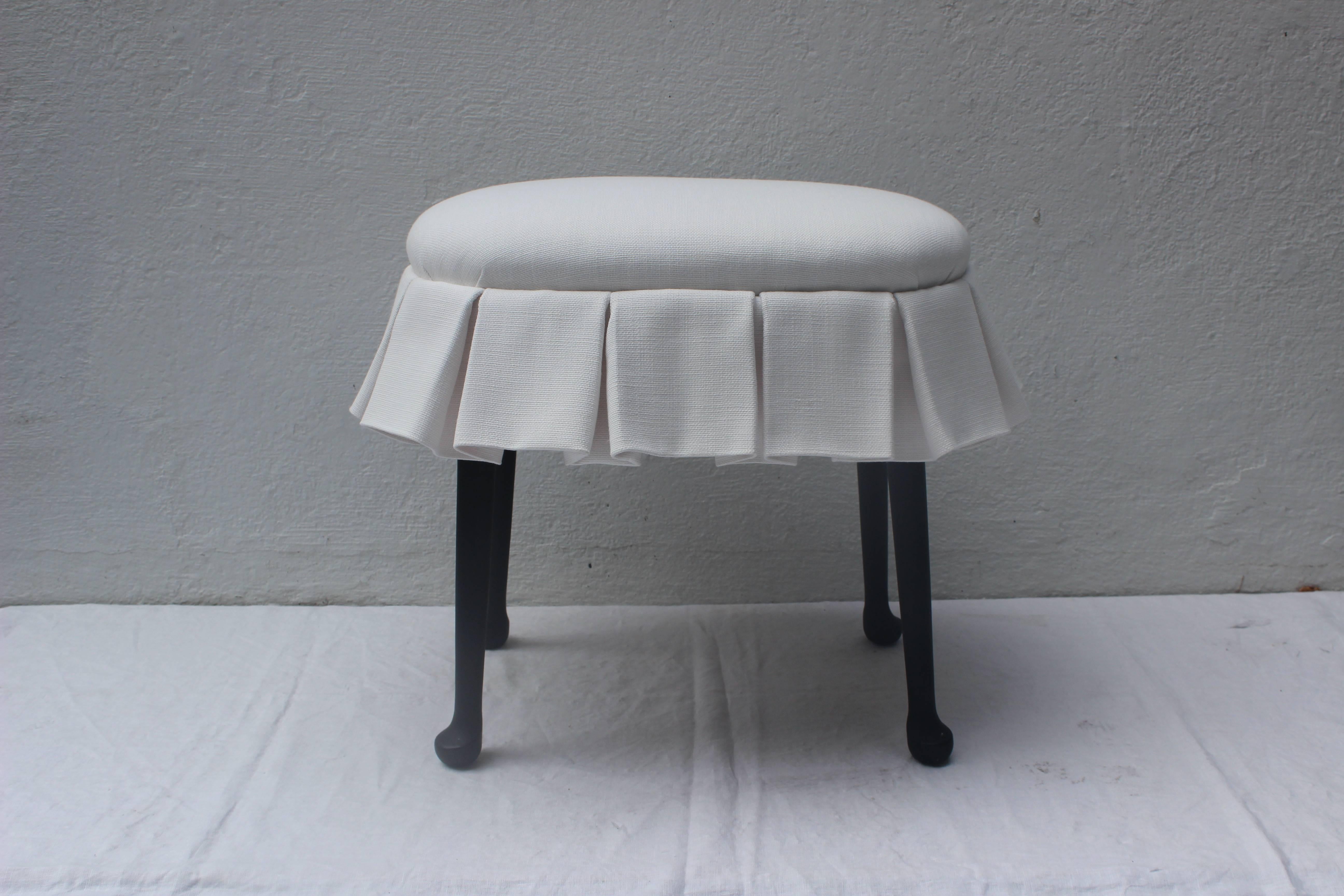 Fabulous oval stool with box pleated skirt upholstered in Perennials outdoor fabric. Ebonized wooden legs.
