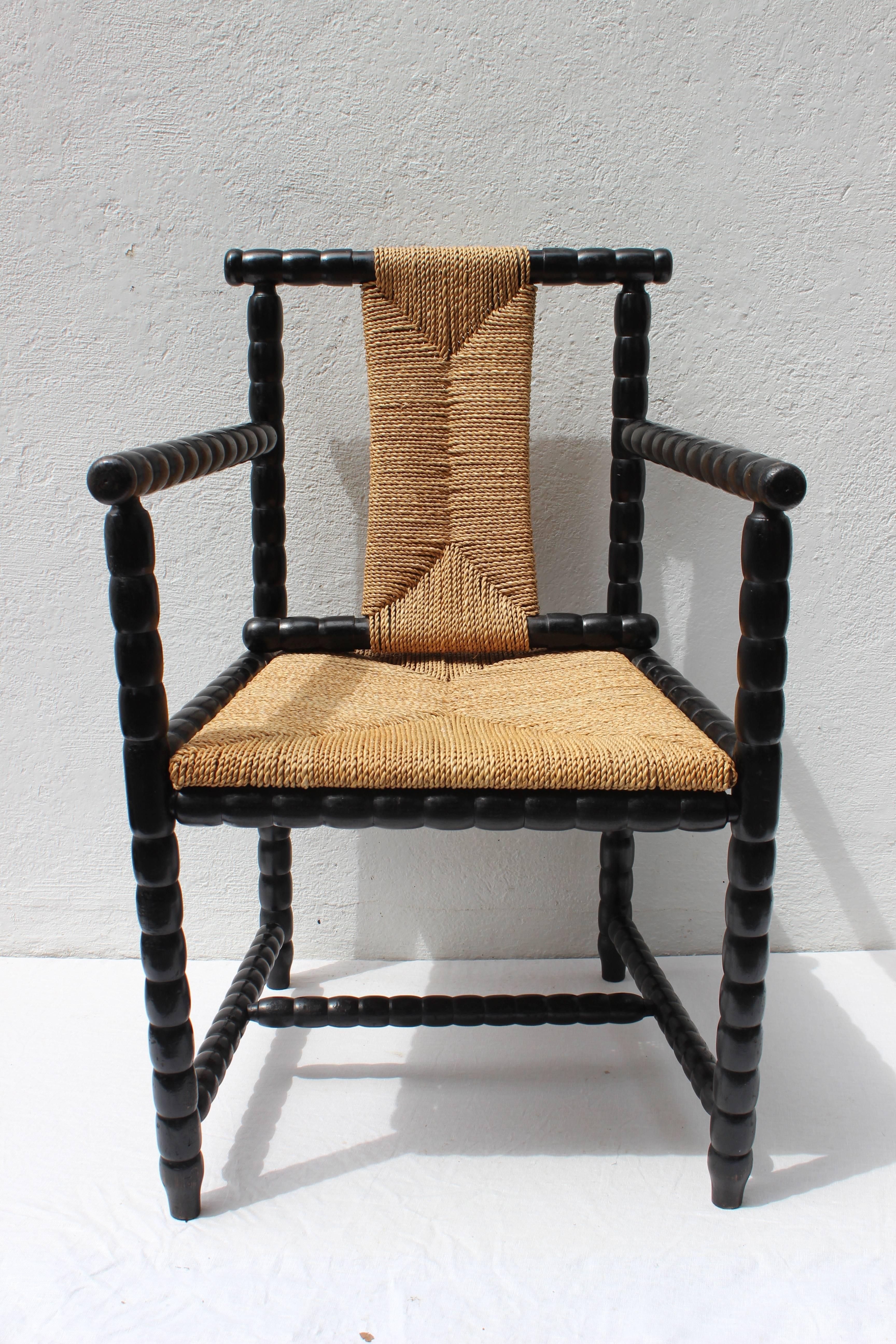 Turned wood armchair with Rush Seat by Josef Zotti. Manufactured by Prag-Rudniker Korbfabrikatio.