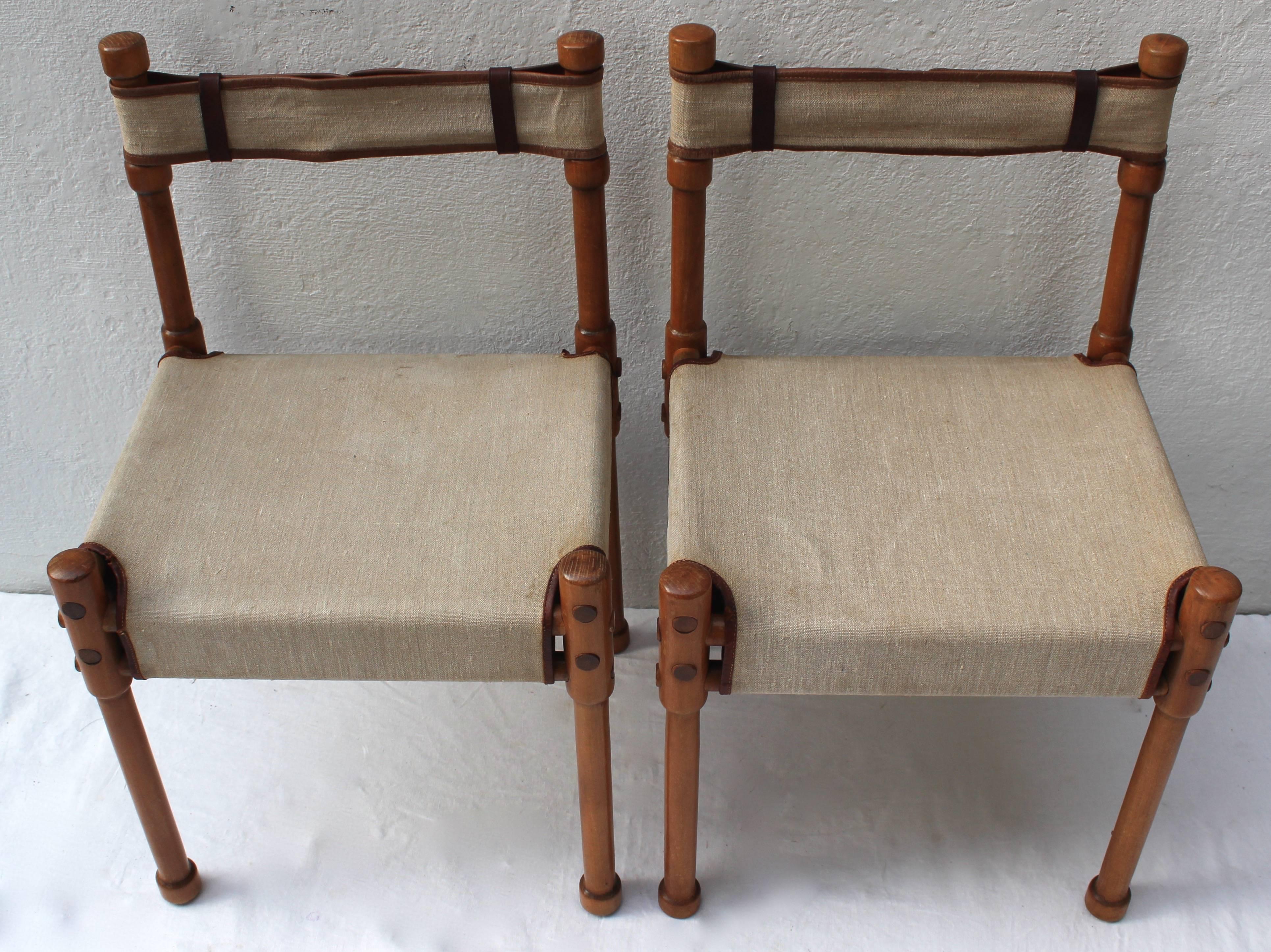 Beautifully restored pair of Campaign chairs with mortise and tenon construction... linen canvas and leather trim seat and back. Light use to piping.