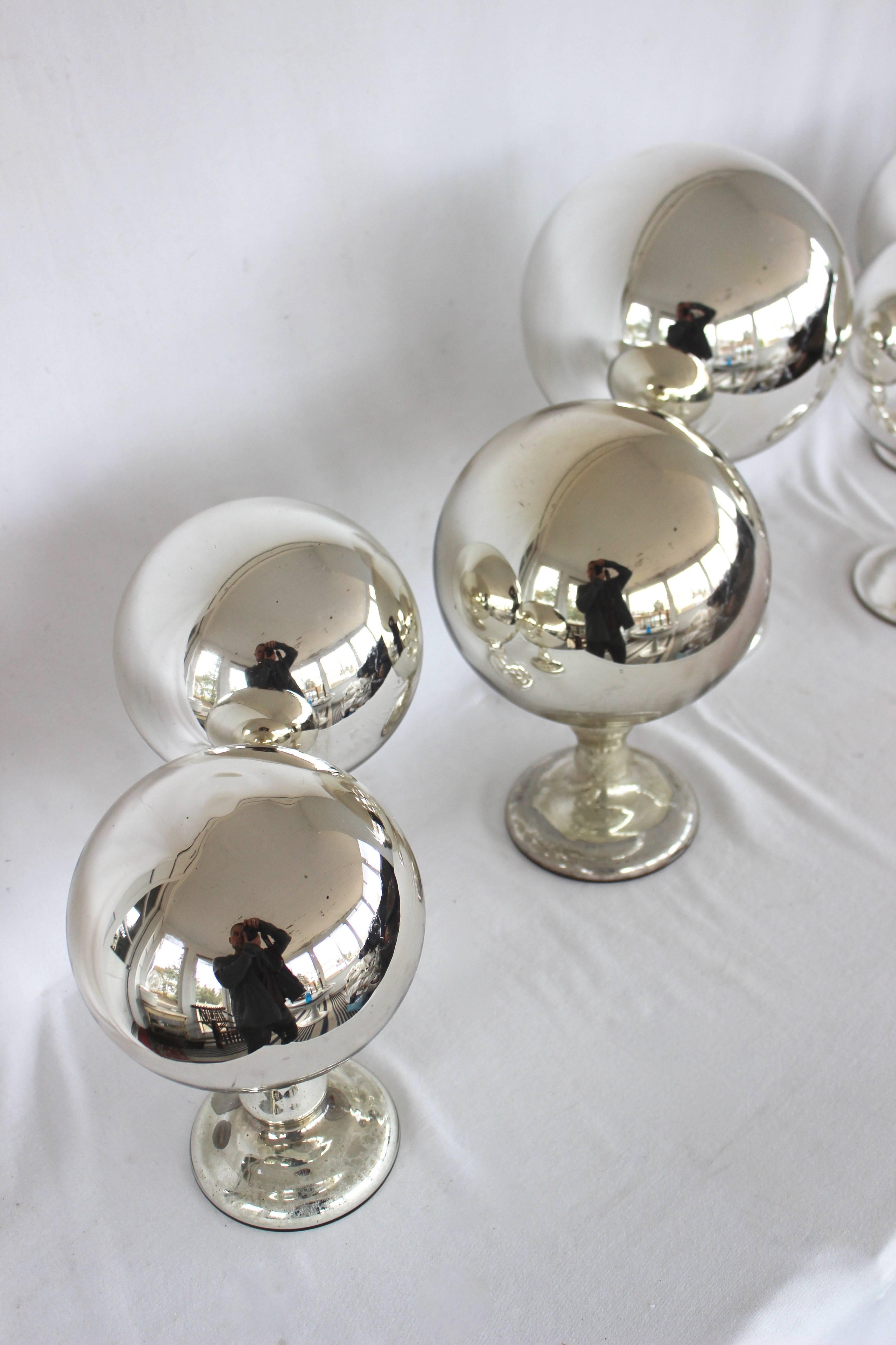 Collection of Mercury Glass Spheres......antique hat stands.....

1 Large - 13.5